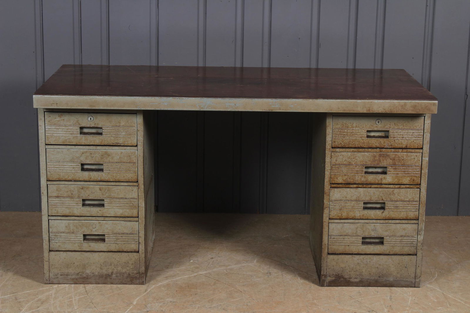 Vintage Industrial Kneehole Desk: Vintage Industrial Kneehole Desk. Steel pedestals under a masonite top. Size: 31.5" H x 60" W x 29" D