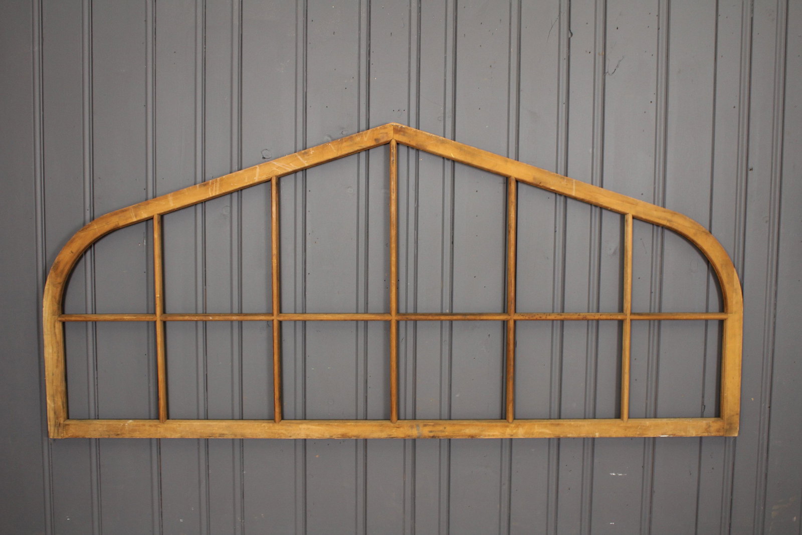 Transome Window: A good turn of the century shaped wood architectural transome window, never been glazed, found unused in a barn. Size: 45.25"H x 101.25"W x 1.75"D