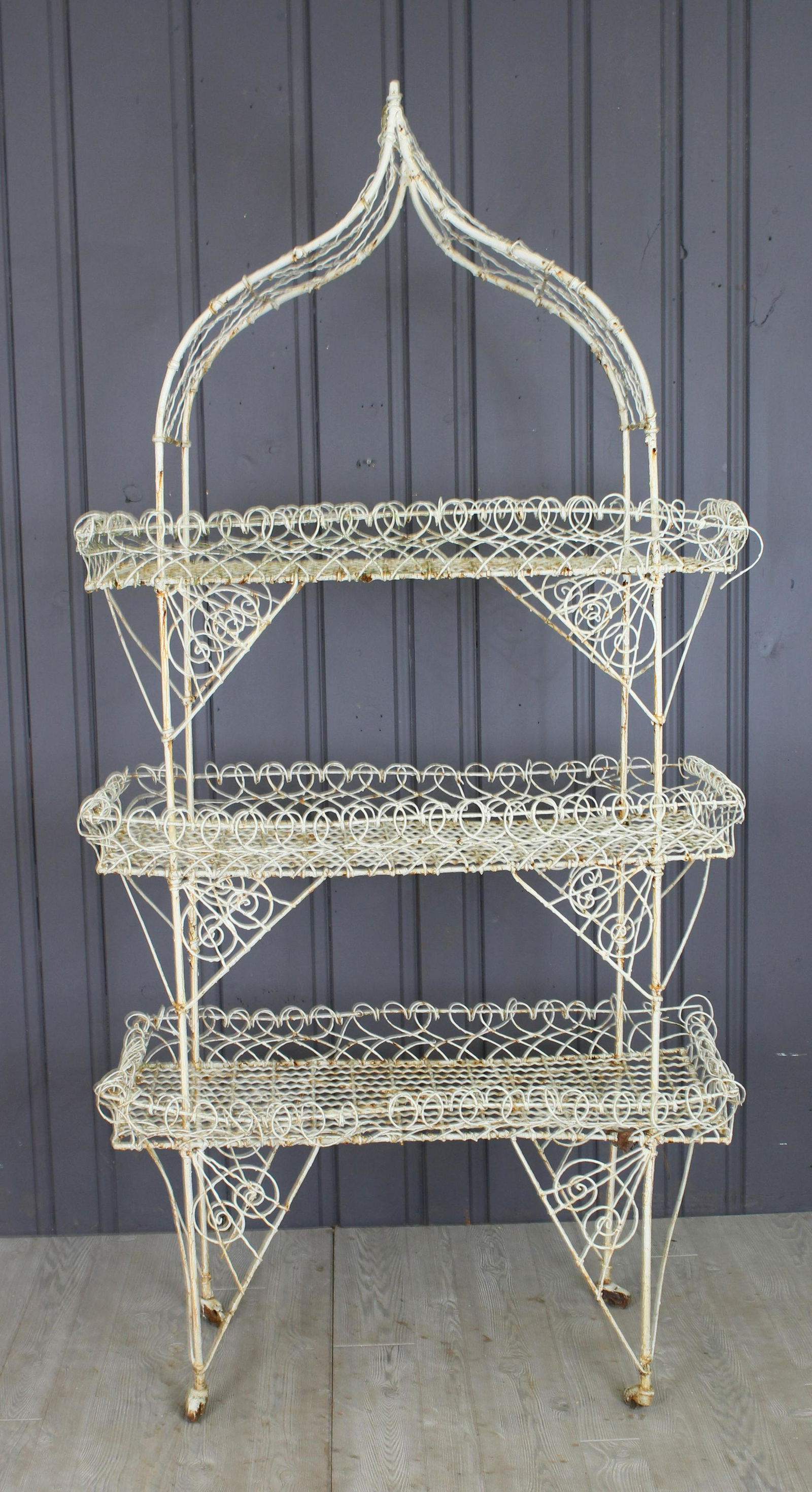 Wirework Plant Stand: Antique French wrought iron wirework three tier garden/conservatory shelf with arched top an over all scroll decoration. 84" H x 42" W x 20" D.