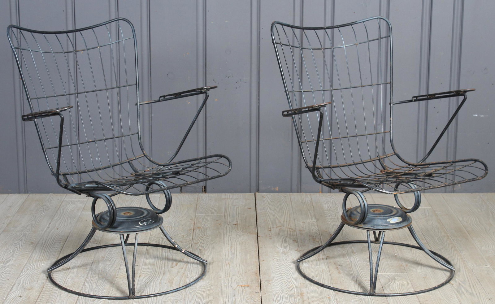 New Jersey Swivel Spring Patio Armchairs: A pair of vintage wrought iron mid century modern New Jersey Spring swivel arm chairs . 33" H x 27" W x 23" D