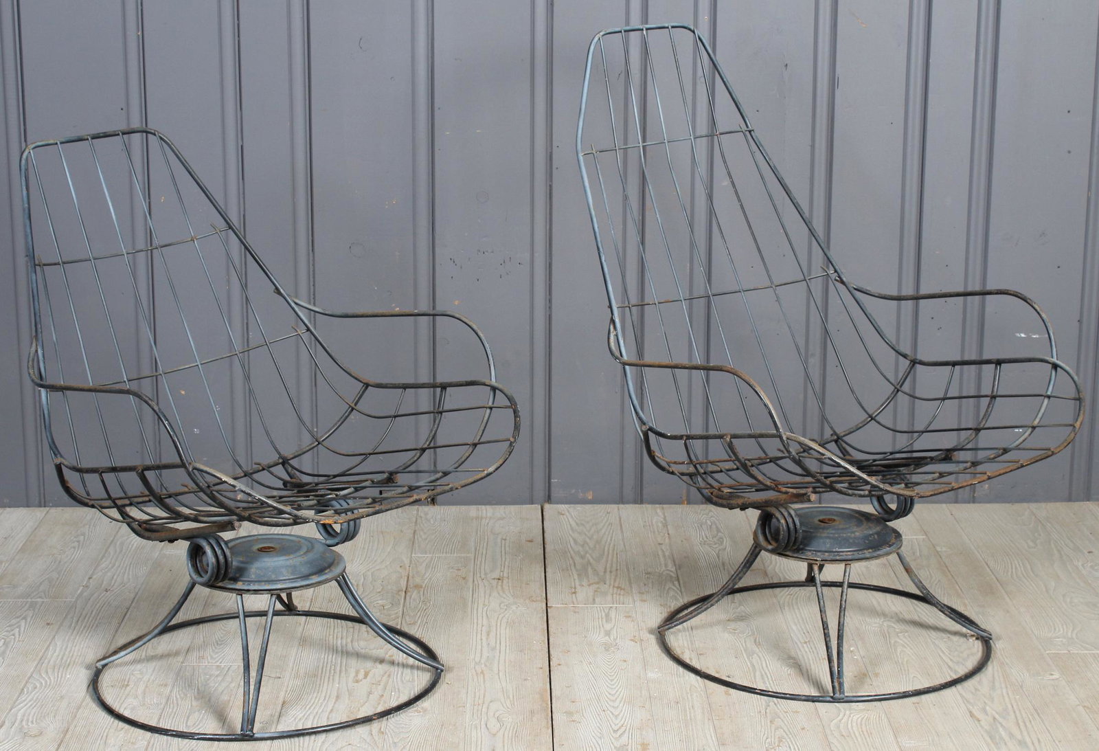 New Jersey Swivel Spring Patio Chairs: An associated pair of vintage wrought iron mid century modern New Jersey Spring swivel garden chairs. Largest 38" H x 25" W x 26" D
