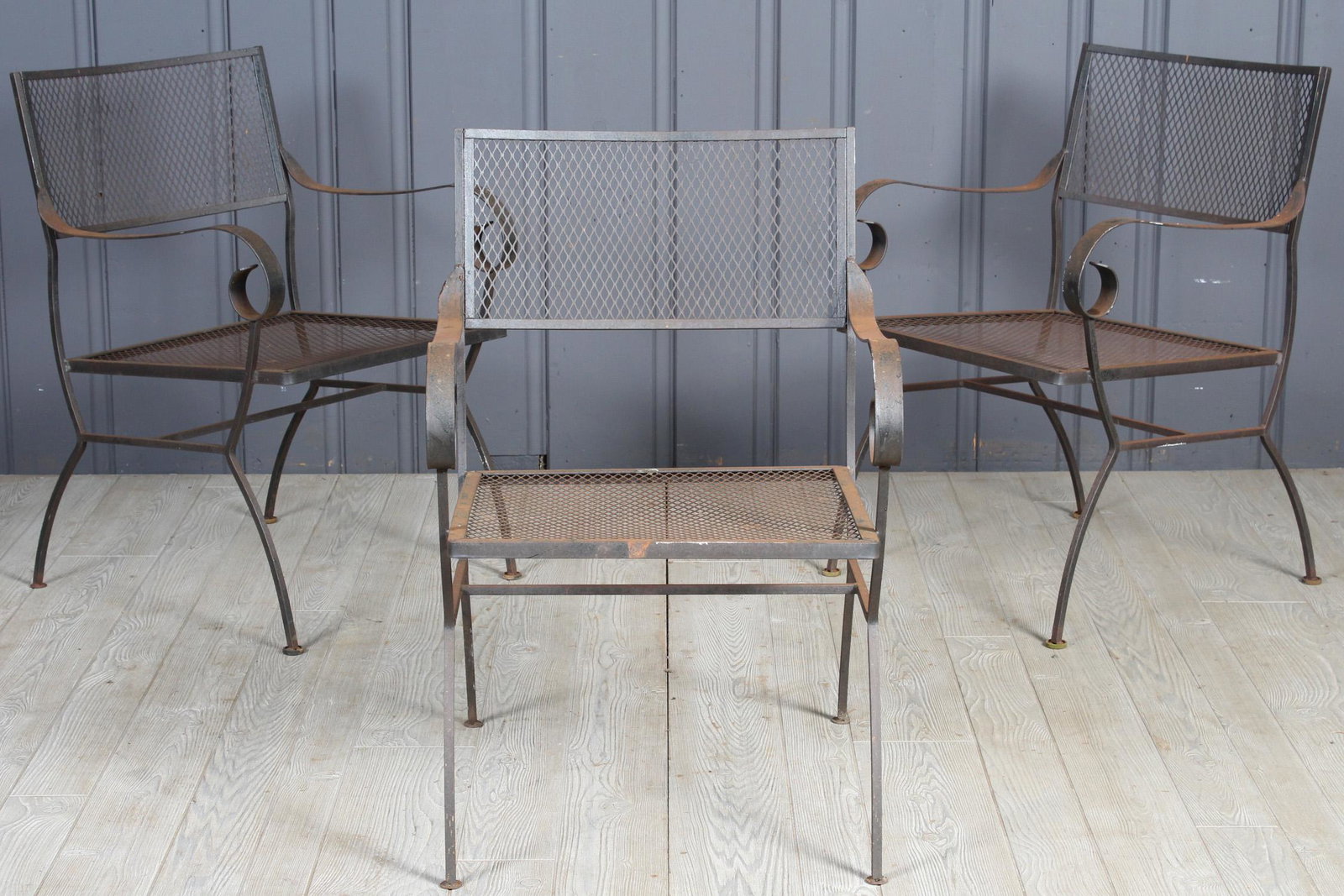 3 Wrought Iron Scroll Armchairs: A set of three vintage wrought iron garden chairs with scrolling arms. 32" H x 21" W x 22" D