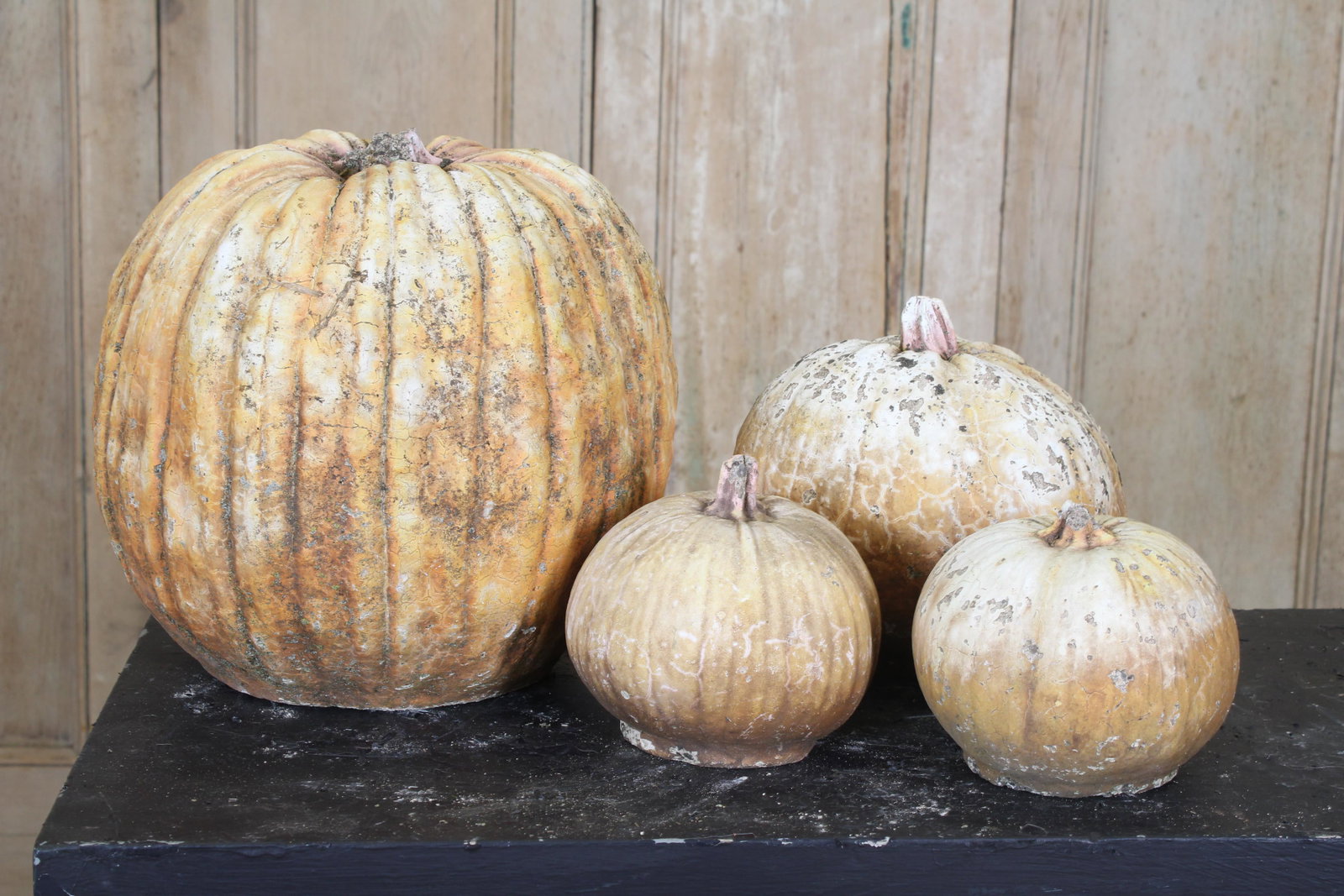 Lot of 4 Sculptural Stone Pumpkins: A lot of 4 vintage cast stone garden pumpkins. Size: largest 12" tall.