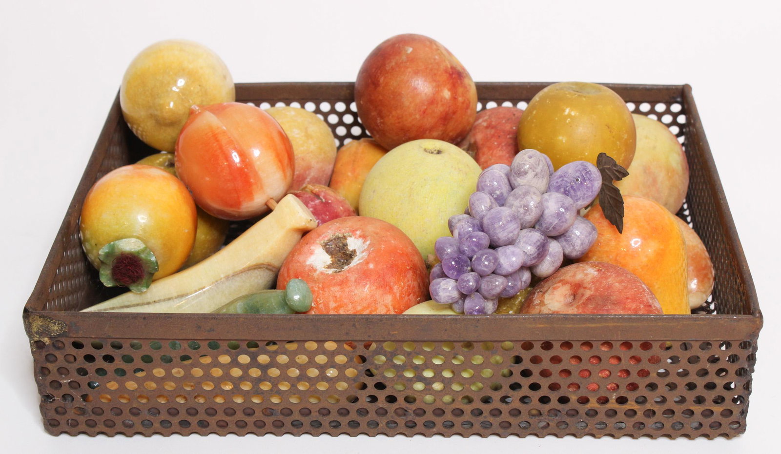 Grouping of Carved Stone and Marble Fruit: Grouping of Carved Stone and Marble Fruit, 23 pieces, including grapes, apples, peaches, carrots, etc. Size: Container: 3" H x 14" W x 10" D ***Please Note: This is an on-site online auction with spec