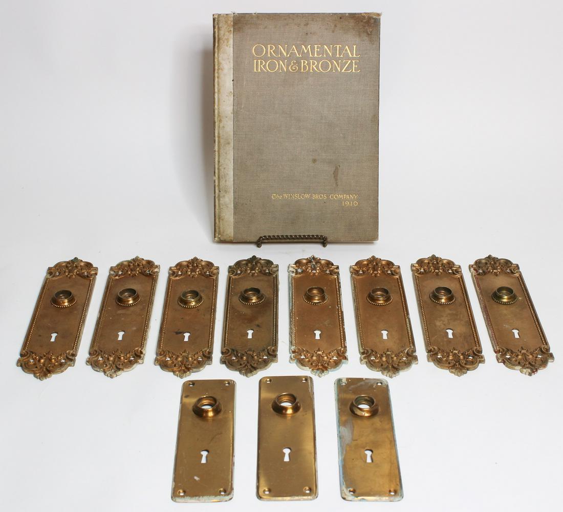 Grouping Bronze Escutcheons and Book: Grouping Bronze Escutcheons and Book, set of eight matching escutcheons, set of three matching escutcheons, and a book, Ornamental Iron & Bronze, by the Winslow Bros. Company, 1910. Size: Largest: 11.
