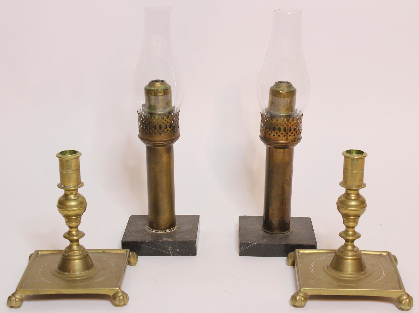 2 Pairs of Candlesticks: 2 Pairs of Candlesticks, includes one pair of oil lamps, stone base, glass shades, and a pair of brass candlesticks, square base with paw feet, hallmarked on bottom Williamsburg Restoration CW 16-5. S