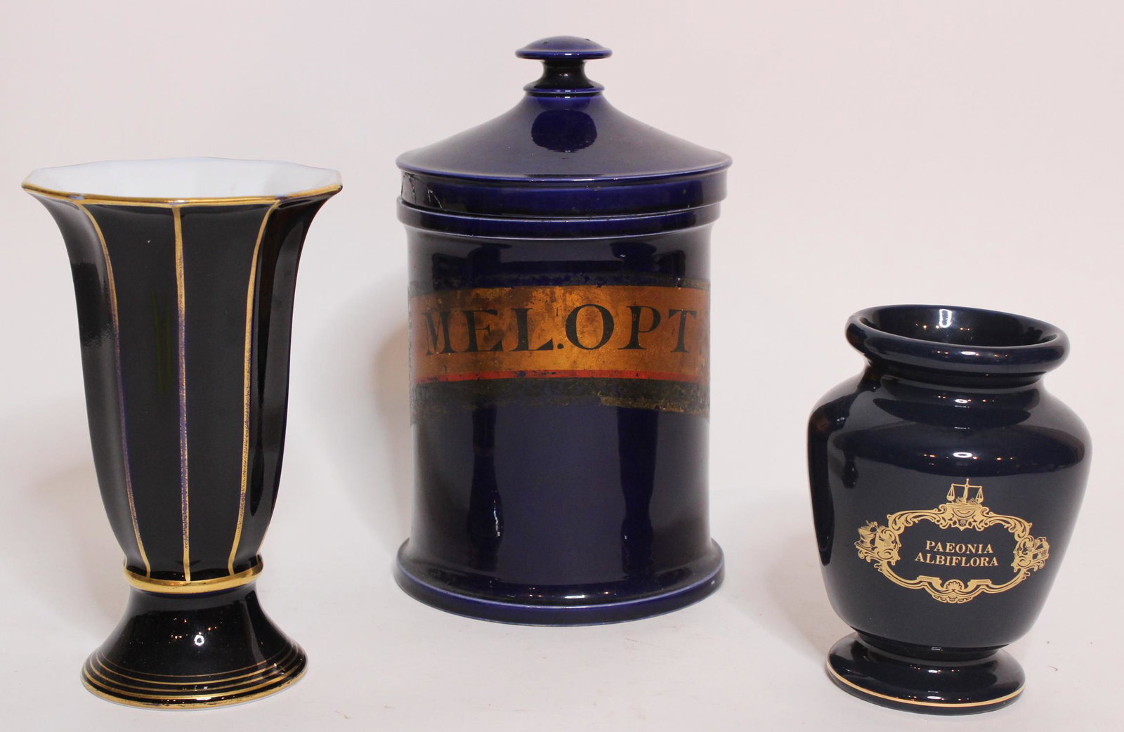 Two Porcelain Vases and a Porcelain Canister: Two Porcelain Vases and a Porcelain Canister, trumpet form vase marked J. L. Menau, von Henneberg- Porzellan, Germany. Smaller vase marked Paeonia Albiflora on front in gilt, and a canister marked Mel