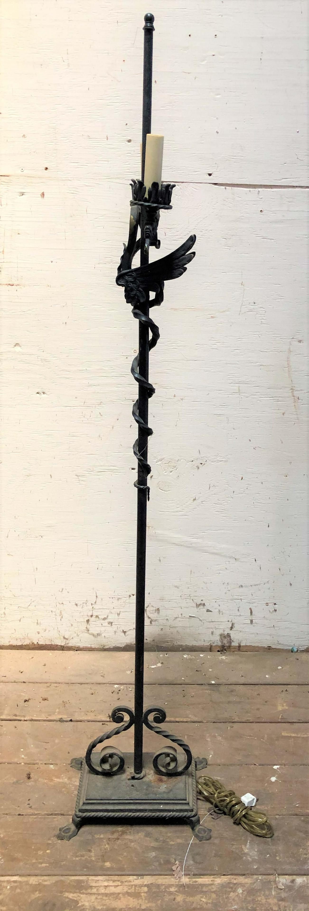 Gothic Style Wrought Iron and Bronze Floor Lamp: Gothic Style Wrought Iron and Bronze Floor Lamp with double griffin arms supported on central post. Size: 56" H x 11" W x 8" D. ***Please Note: This is an on-site online auction with specific Pick up 
