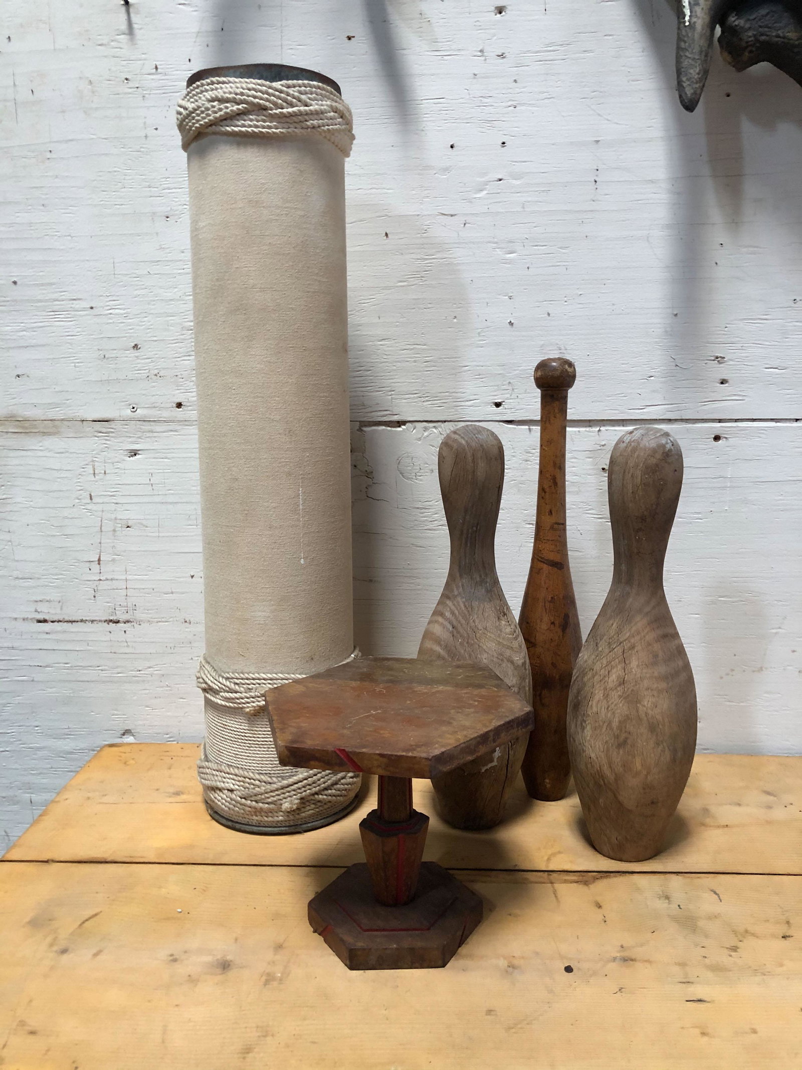 5 Pc Curiosity Lot: Interesting Object Lot, including a pair of carved wood bowling pins, Indian club, an Art Deco stand and a trench art nautical rope wrapped mortar shell. ***Please Note: This is an on-site online auct