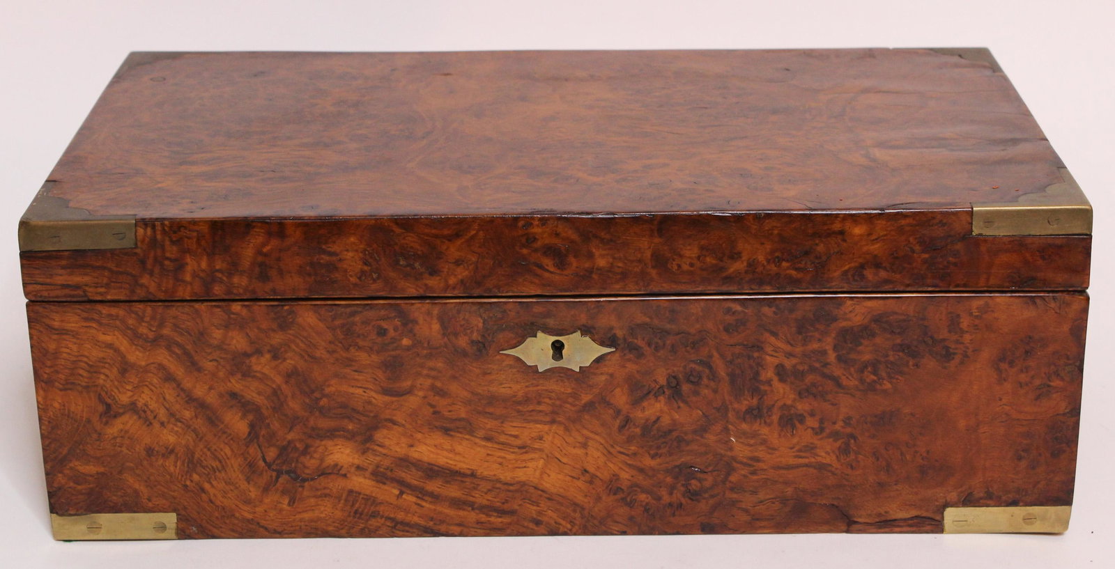 Burled Walnut Lap Desk: Burled Walnut Lap Desk, tooled leather writing surface, lifts up for storage and three hidden interior drawers, four slots and a pen holder, one lid, and a glass inkwell with no lid, brass mounted cor