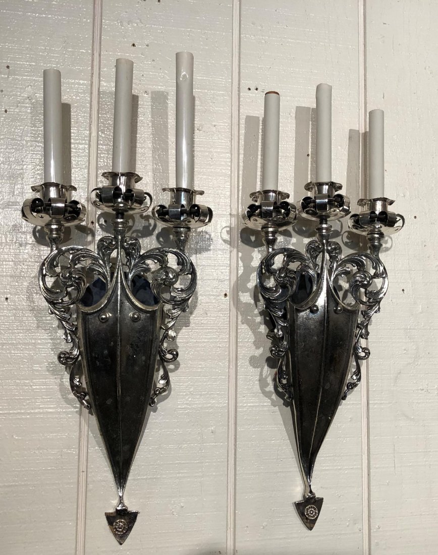 Pair of Electrified Wall Sconces: Pair of Electrified Wall Sconces, shield and scroll design, triple light. ***Please Note: This is an on-site online auction with specific Pick up terms and conditions. Pick up day is scheduled for 8/2