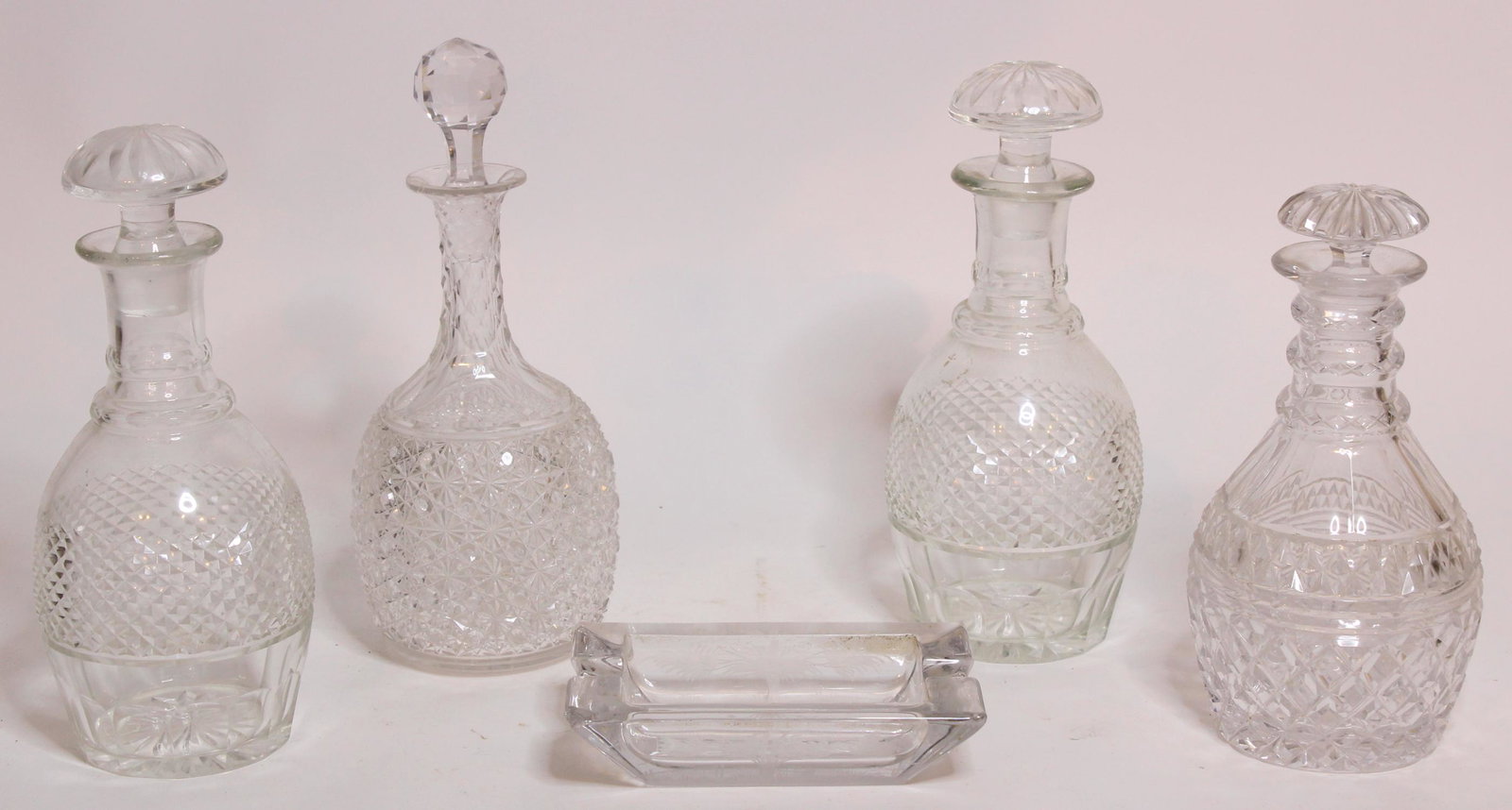4 Cut Glass Decanters & Etched Glass Ashtray: 4 Cut Glass Decanters & Etched Glass Ashtray depicting a dog. Size: 11" H x 4.5" W x 4.5" D ***Please Note: This is an on-site online auction with specific Pick up terms and conditions. Pick up day is