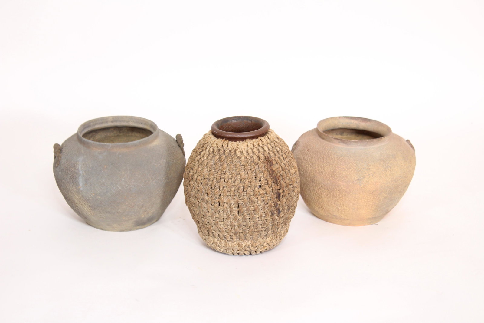 Two Chinese Pottery Jars and Additional Jar: Two Chinese pottery jars and a jar with woven cover. Size: largest 7"H x 6"Dia. ***Please Note: This is an on-site online auction with specific Pick up terms and conditions. Pick up day is scheduled f