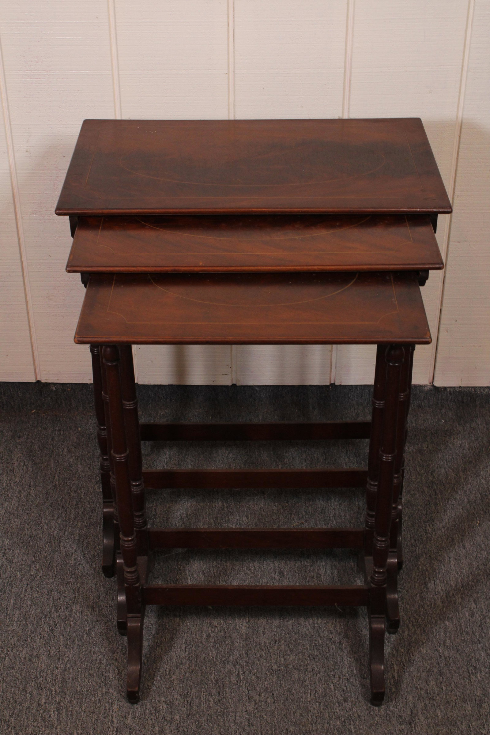 Set of Three Inlaid Mahogany Nesting Tables: Set of three inlaid nesting tables. Size: 28"H x 22"W x 13.5"D ***Please Note: This is an on-site online auction with specific Pick up terms and conditions. Pick up day is scheduled for 8/29 in Frazer