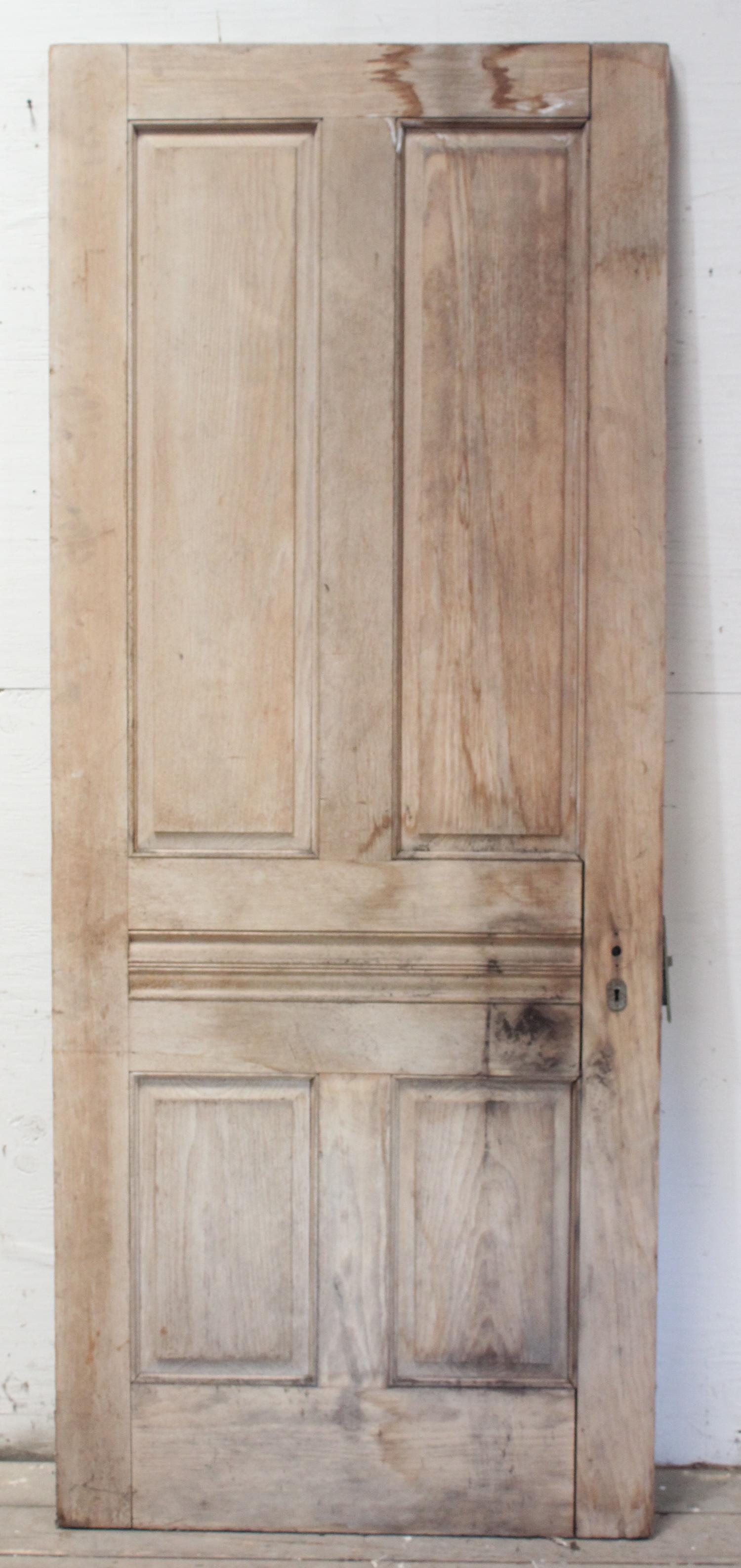 Antique Stripped Pine Raised Panel Door: A good antique stripped pine raised panel door. Size: 83"H x 34"W ***Please Note: This is an on-site online auction with specific Pick up terms and conditions. Pick up day is scheduled for 8/29 in Fra