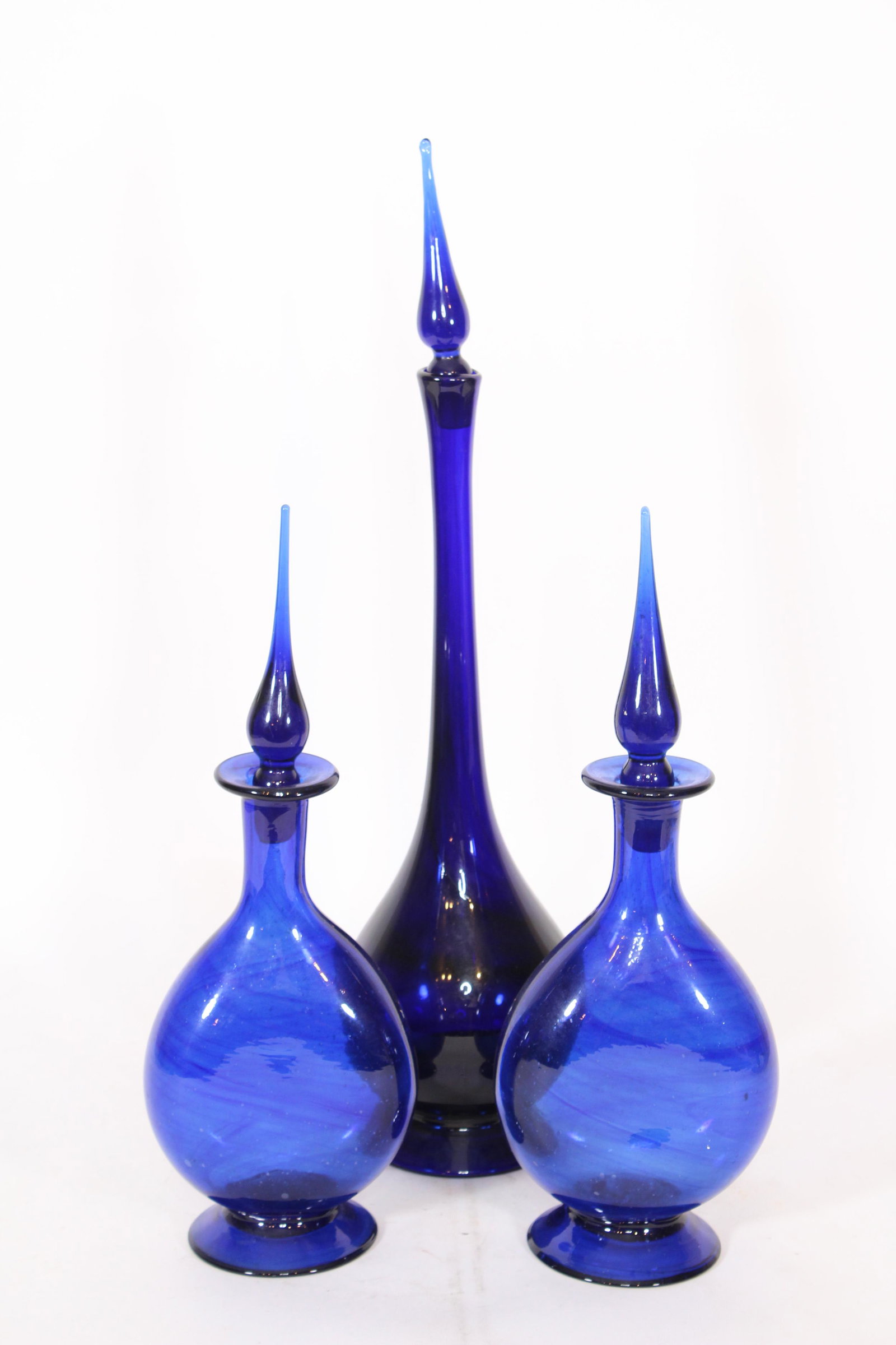 3 Cobalt Glass Decanters: 3 Cobalt Glass Decanters, hand blown. Size: Largest: 23.25" H x 5.5." Diameter. ***Please Note: This is an on-site online auction with specific Pick up terms and conditions. Pick up day is scheduled f