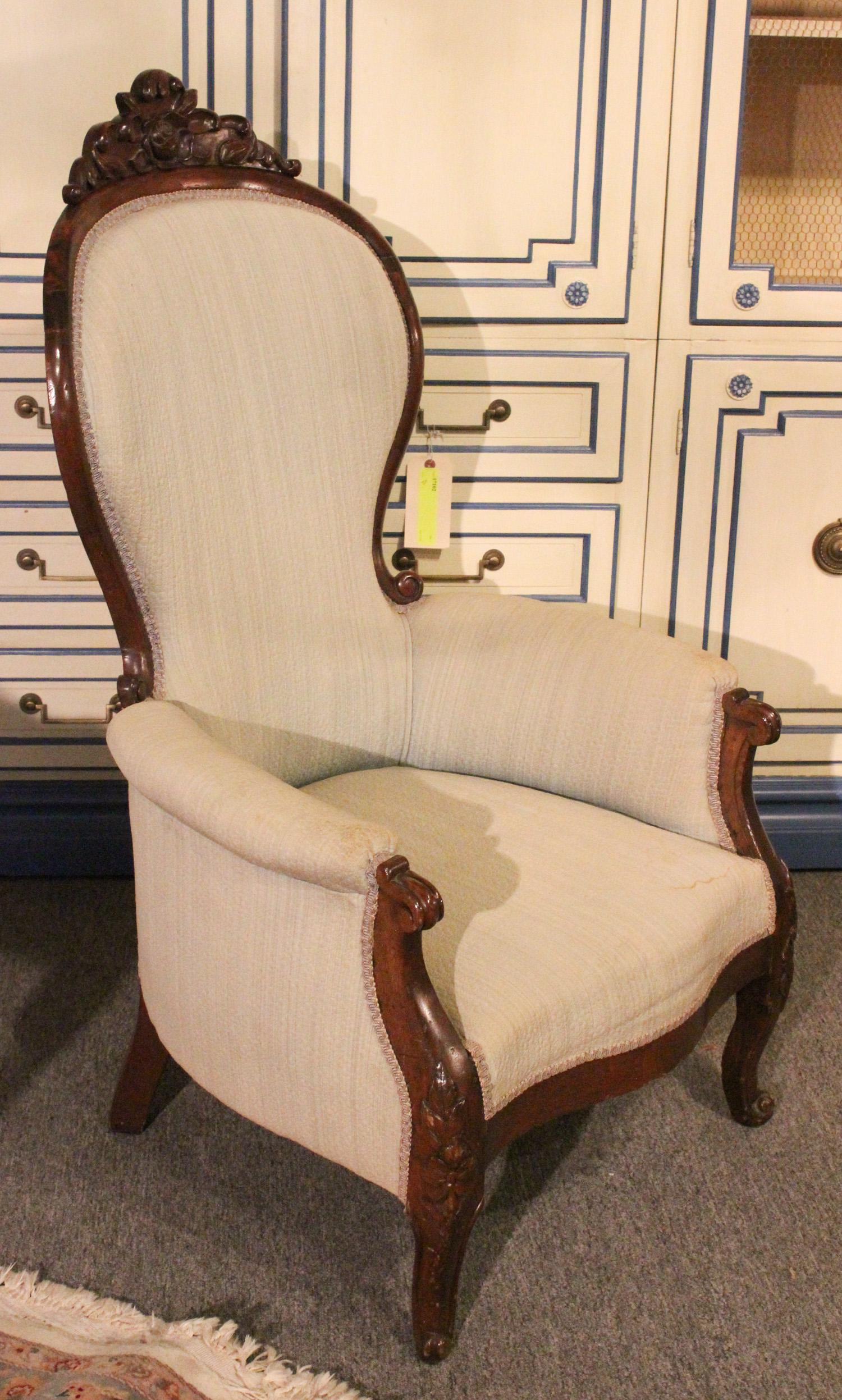 American Victorian Carved and Upholstered Chair: American Victorian Carved and Upholstered Salon Chair. Having floral carved back crest and shaped arms. Size: 44" x 27" x 22" ***Please Note: This is an on-site online auction with specific Pick up te