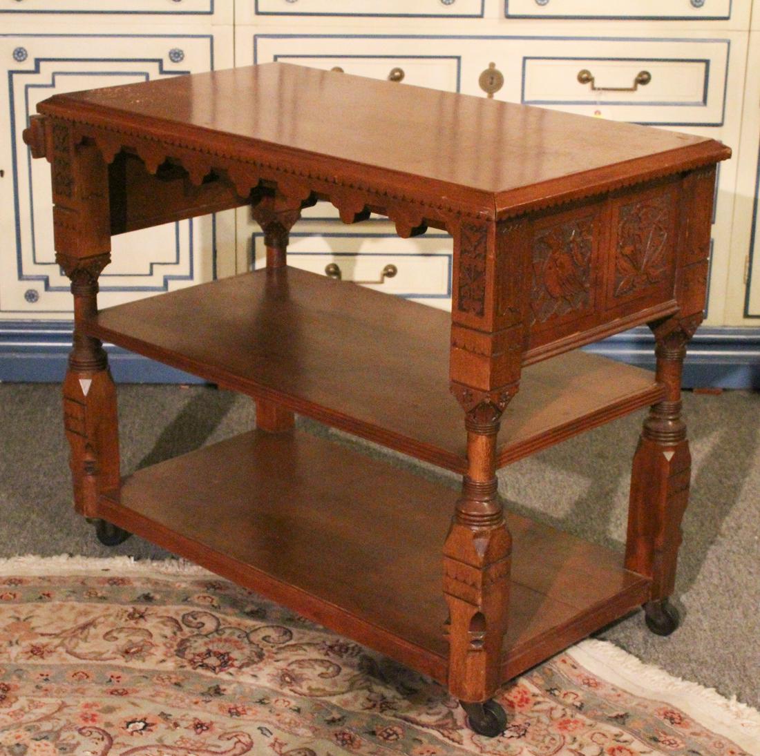 Pabst Inspired American Victorian Serving Cart: A rare form of American Victorian carved serving cart in the Daniel Pabst style with decorated top edge over open shelves supported on turned and incise carved column form legs. Size: 30" x39" x 20" *