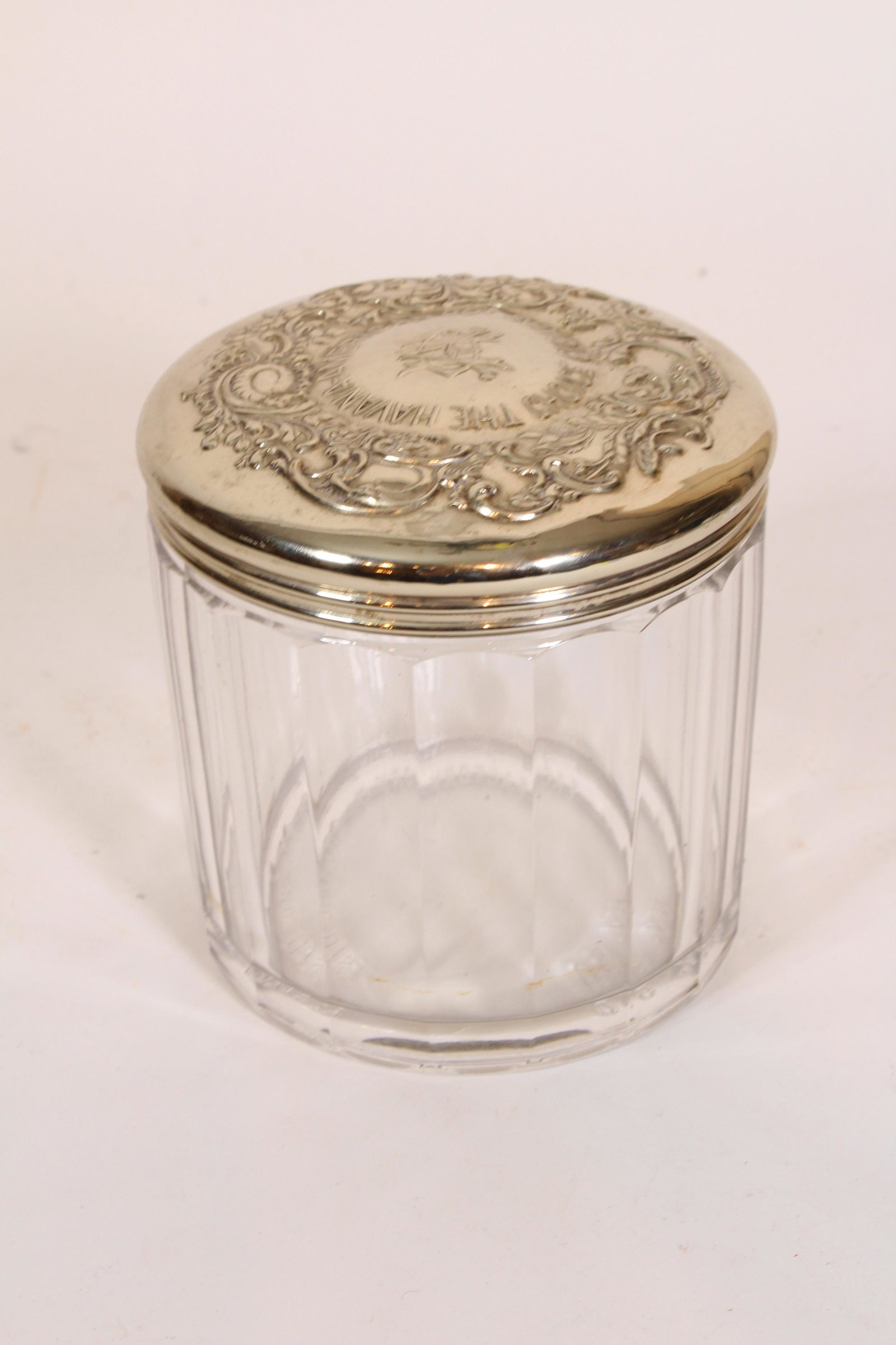 The Havana-American Co's Glass Cigar Humidor: The Havana-American Co's Choice Cigar Glass Humidor. Silverplate lid. Size: 5.5" x 5.25" diameter ***Please Note: This is an on-site online auction with specific Pick up terms and conditions. Pick up 