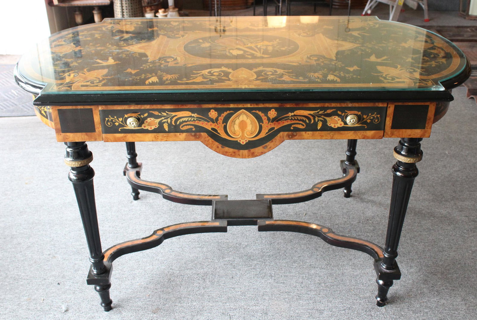 Napoleon III Style Center Table: A Napoleon III style ebonized and marquetry inlaid center table with single drawer. Late 20th century. Size: 31"H x 55"W x 29"D ***Please Note: This is an on-site online auction with specific Pick up 
