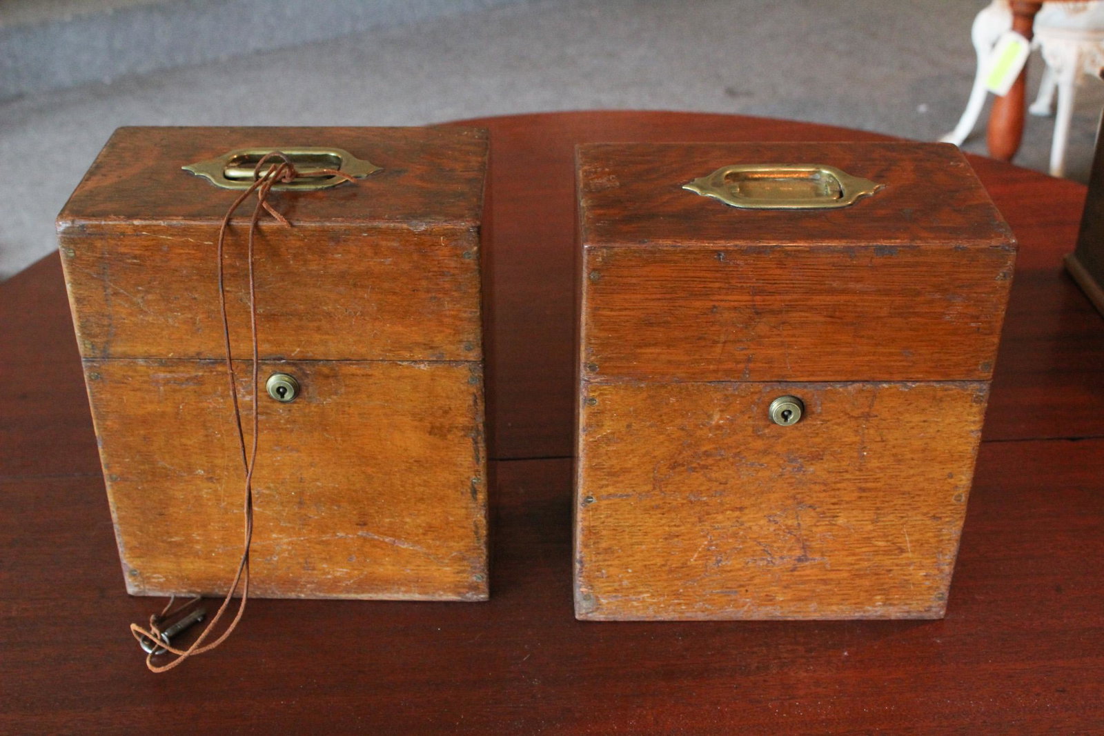 Pair of Antique Campaign Style Bottle Boxes: A pair of antique style boxes with fitted interior holding glass bottles- boxes having Bramah locks. Size: 11"H x 10"W x 5.5"D ***Please Note: This is an on-site online auction with specific Pick up t
