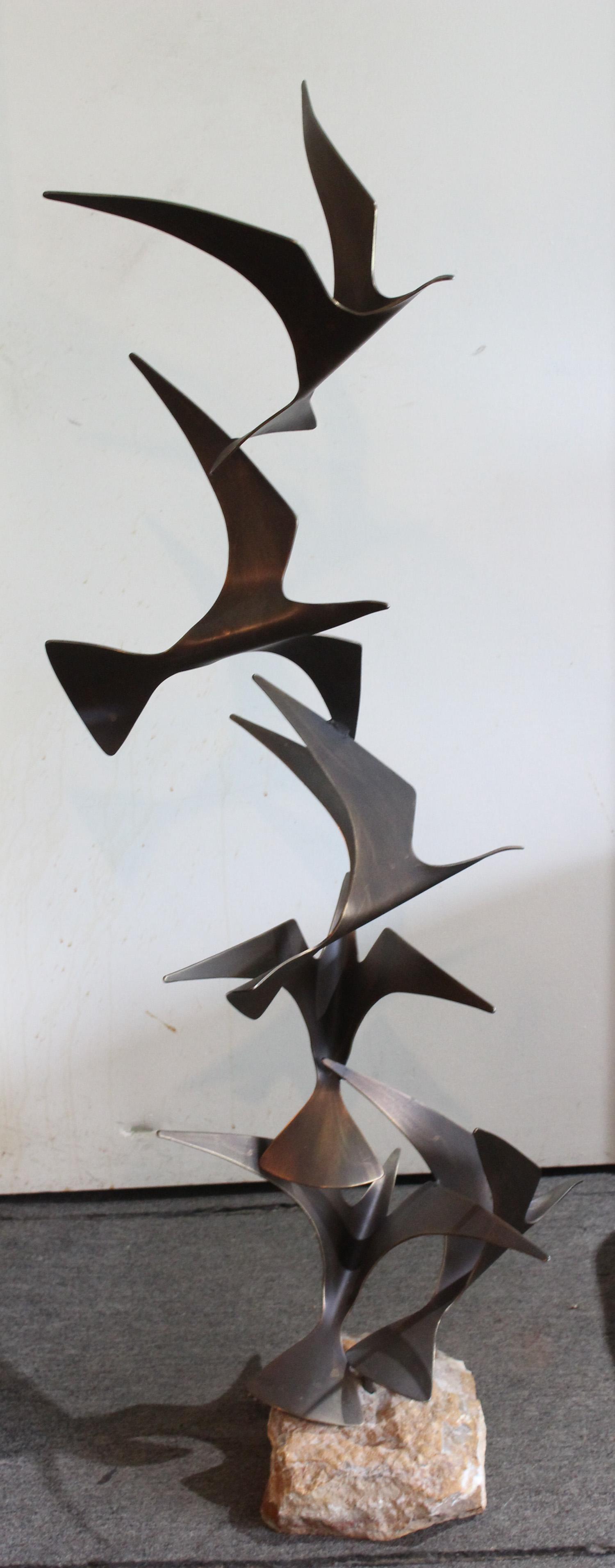 Signed Curtis Jere Flying Birds Group: A signed Curtis Jere and dated 1981. Bronze flying bird sculpture supported on rock base. Size: 47" Tall ***Please Note: This is an on-site online auction with specific Pick up terms and conditions. P