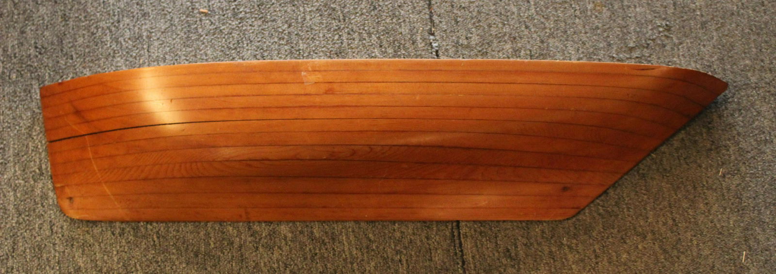 Stacked Wood Half Hull Ship Model: A good stacked wood half hull ship model Size: 6"H x 30.5"W x 4.5"D ***Please Note: This is an on-site online auction with specific Pick up terms and conditions. Pick up day is scheduled for 8/29 in F