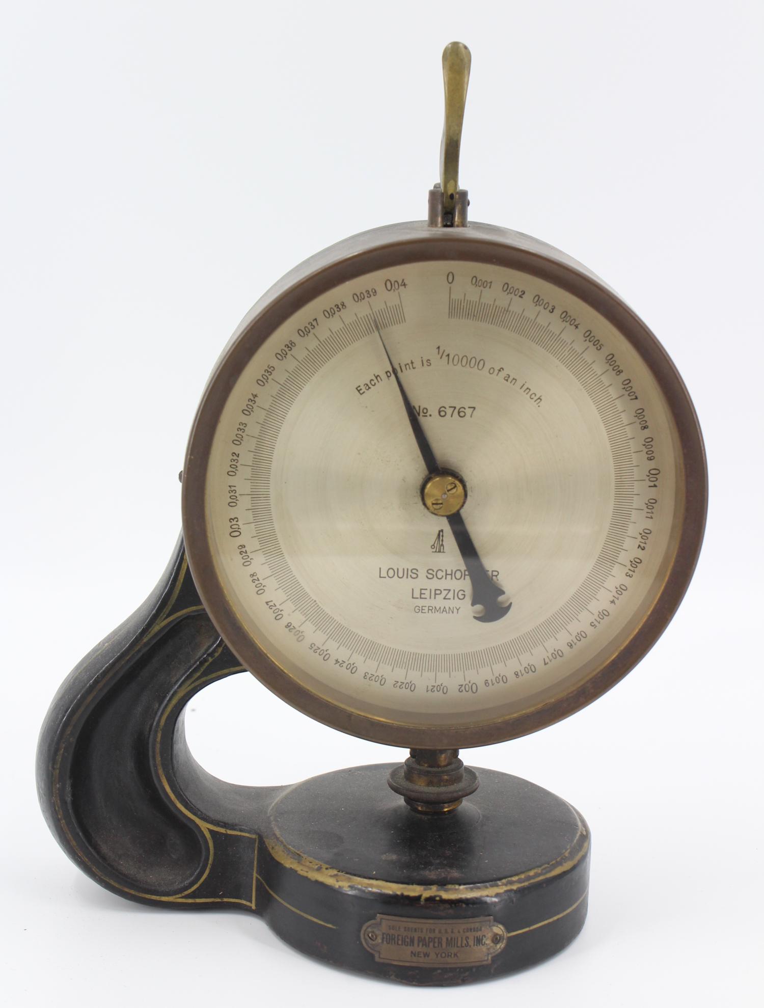 Louis Schopper German Micrometer: Louis Schopper German Micrometer, marked on face Each Point is 1/10000 of an inch, No. 6767, Louis Schopper, Leipzig, Germany. Plaque on front of base marked Foreign Paper Mills, Inc, New York, Sole A