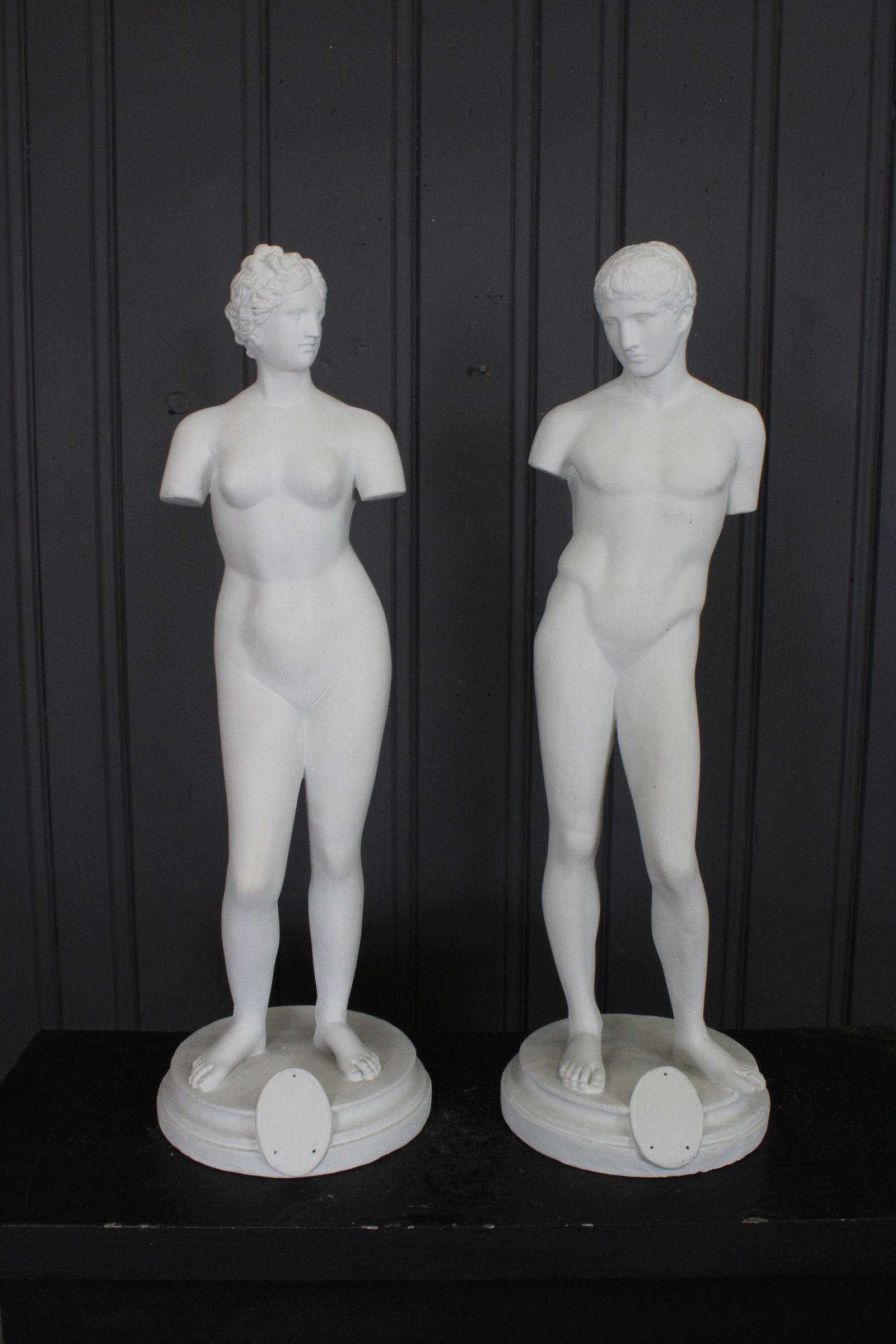 Grand Tour Style Plaster Nudes: A lot of two neoclassical early 20th century plaster grand tour style figures possibly representing David and Diana, both raised on stepped base. Remnant of label. Size: 31"H
