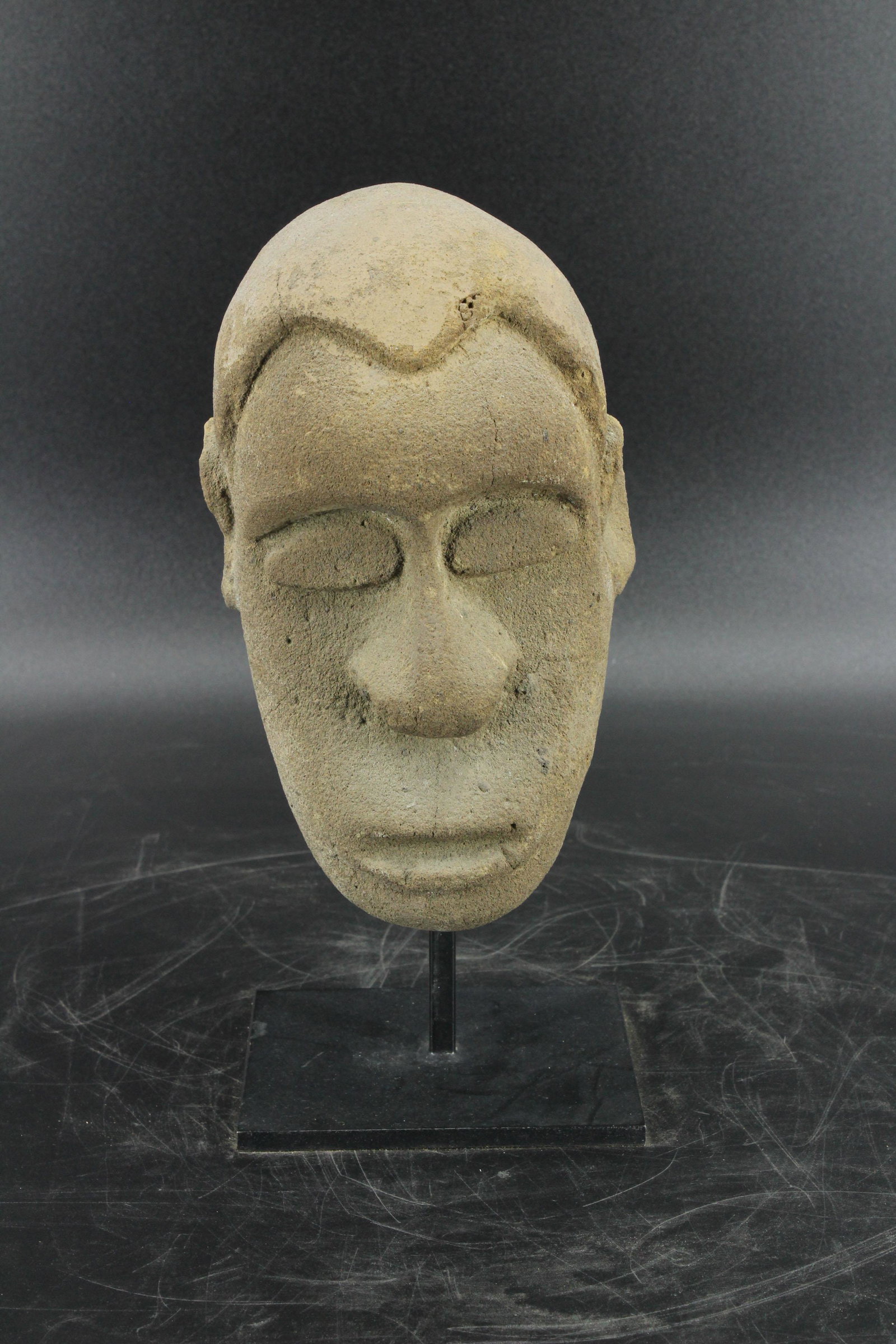 Craved Stone Head: Craved Stone Head. Origin unknown, possibly Yoruba or pre-Columbian. Size: 10"H x 4.5"D x 4"W