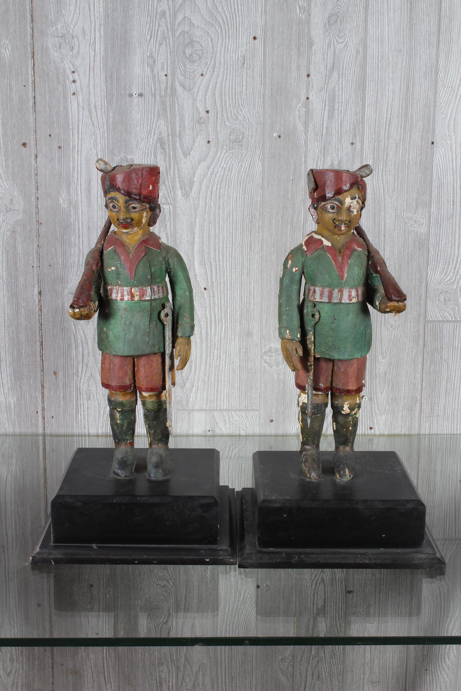 Pair Anglo Indian Carved Wood Sentries: A pair of Anglo Indian carved and painted guard figures each with uniforms. Size: 21.5" H x 7" W x 5" D