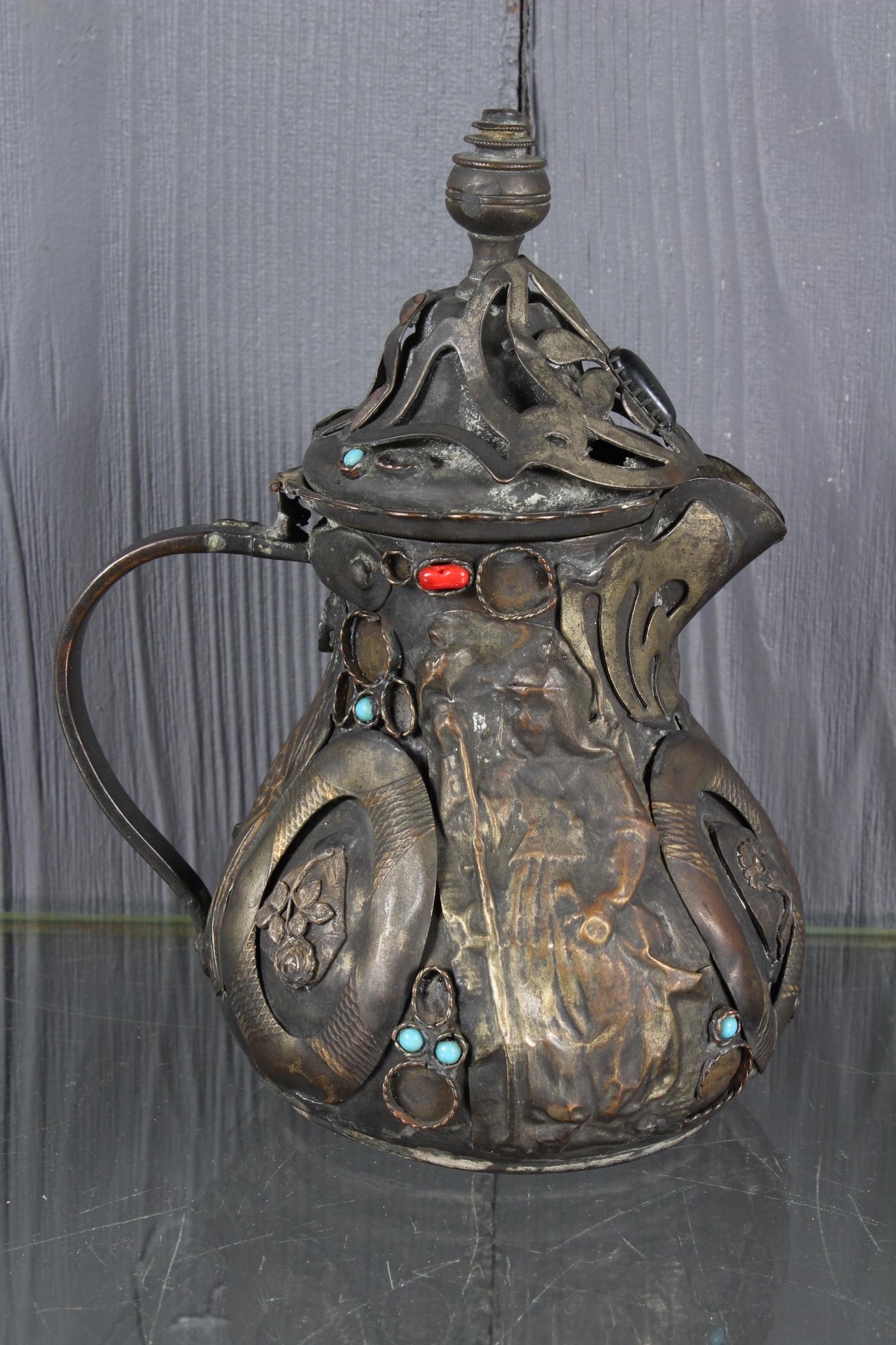Folk Art Memory Tea Pot: Folk Art Memory Tea Pot, with applied metal objects and jewels, figural and floral designs. Size: 7" H x 5.5" W x 4" D