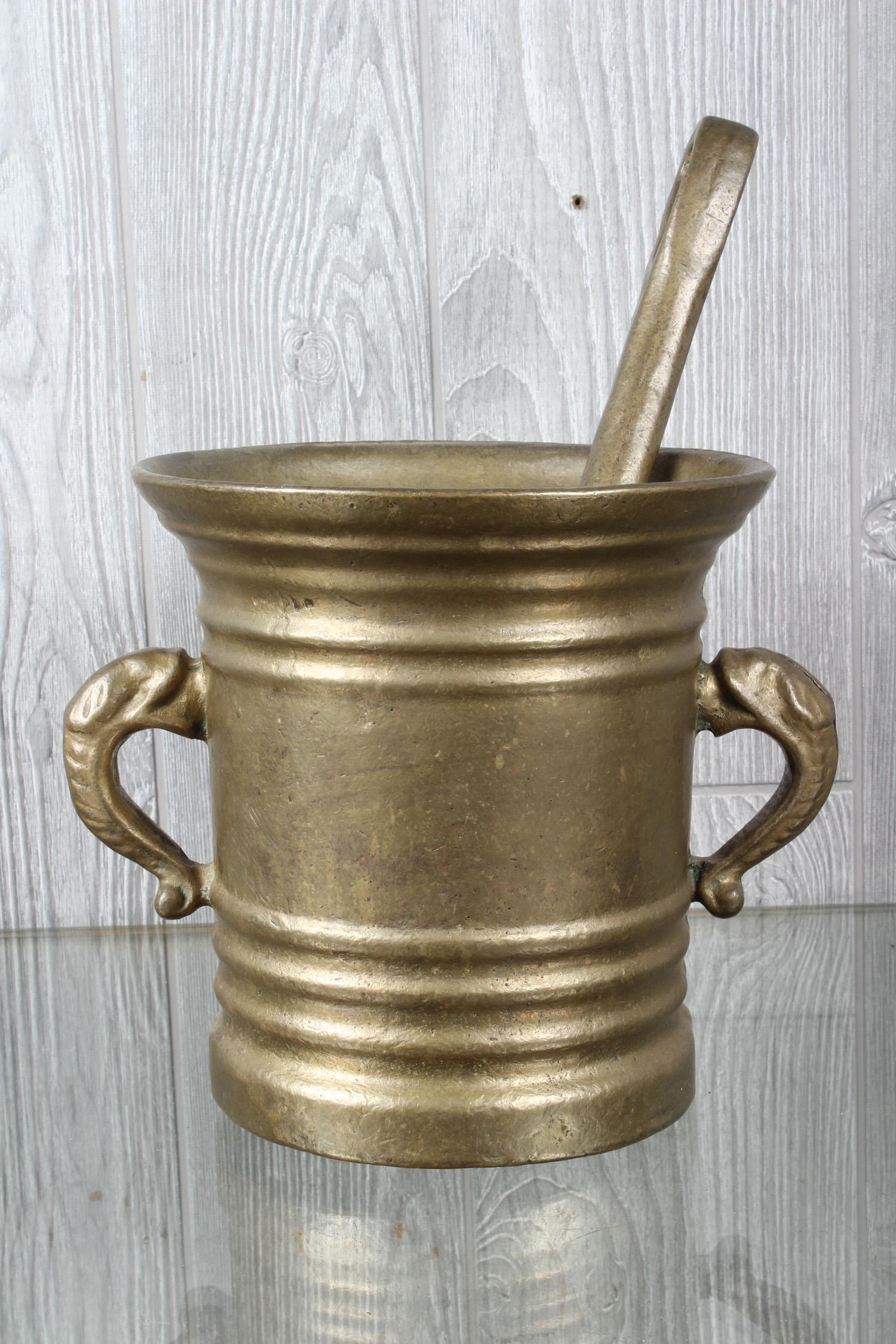 Bronze Mortar and Pestle: A bronze mortar and pestle. Size: Mortar: 8" H x 9" W x 8" D