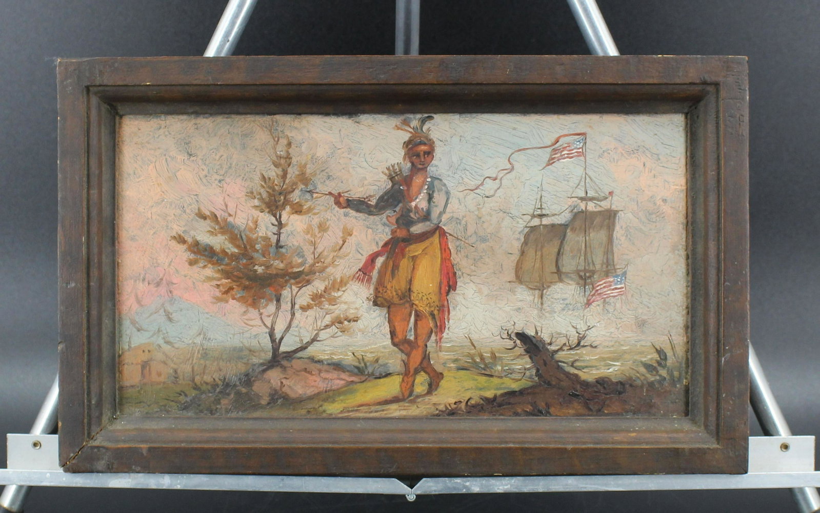 Folk Art Native American Oil Painting: Native American Oil Painting, oil on board, Native American holding arrows with early American flagged ships in the background, unsigned. Size: Frame: 8" H x 13" W, Sight: 5.75" H x 11" W. (NHJ NN)