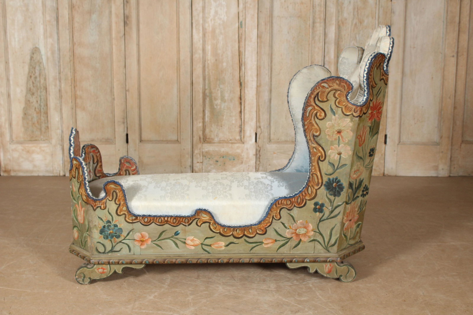 Italian/Venetian Paint Decorated Chaise Lounge: A very good antique Italian/ Venetian paint decorated chaise lounge having scroll and paint decorated sides all raised on shaped feet. Size: 45"H x 56"W x 23"D