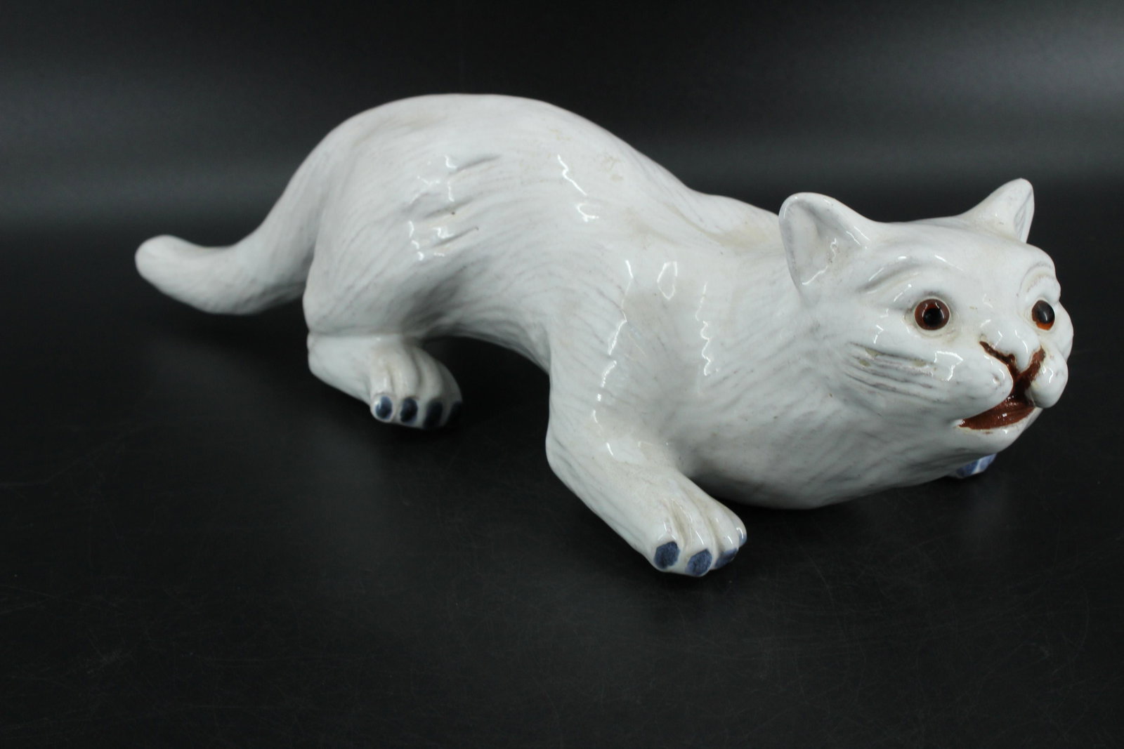 A Vintage Italian/French Glazed Porcelain Cat: A Vintage Italian/French Glazed Porcelain Cat with glass eyes. 5" H x 19.5" W x 6.5" D