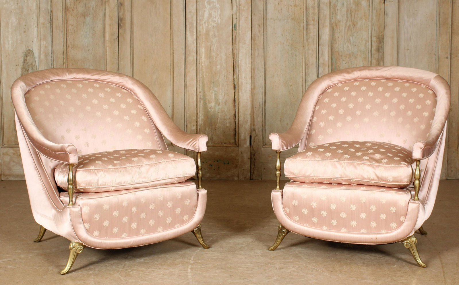 Pair of Italian Mid Century Modern Club Chairs: A pair of Italian Mid Century Modern upholstered club chairs having arched back with down swept arms supported on brass balustrade framing loose cushion, all raised on brass/bronze feet. Size: 33"H x 