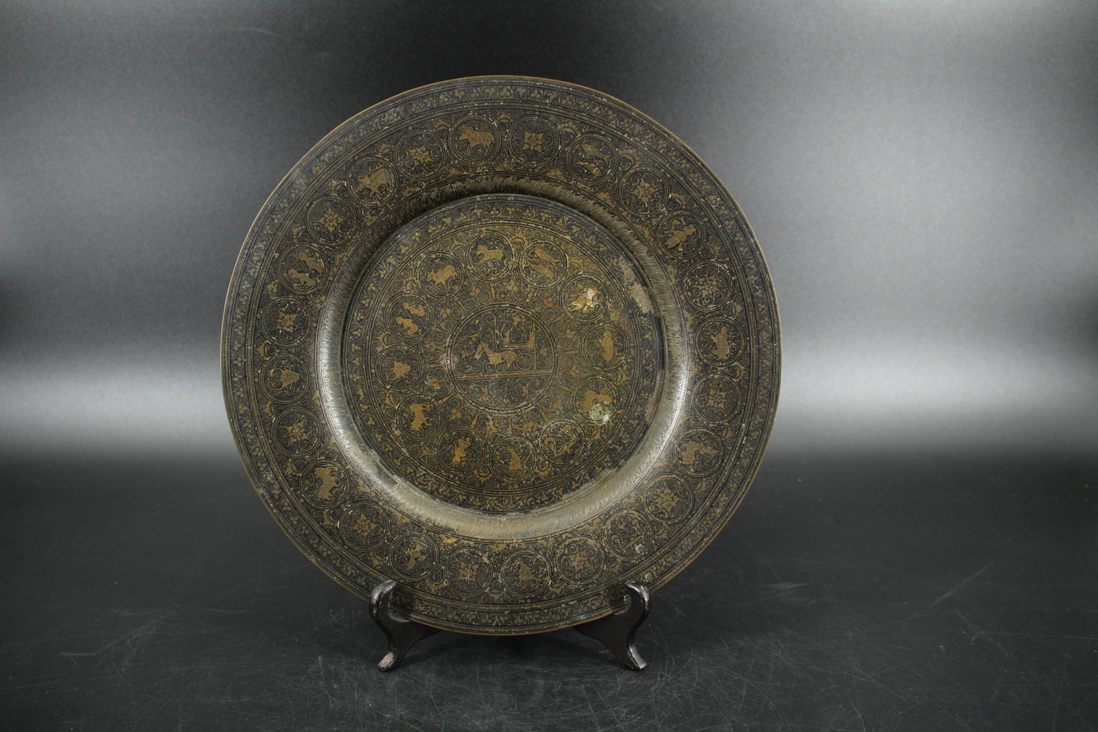Antique Indian Niello Brass Plate: Antique Indian Niello Brass Plate, black etched depicting zodiac signs, center medallion of donkey pulling chariot. Size: 11.75" diameter