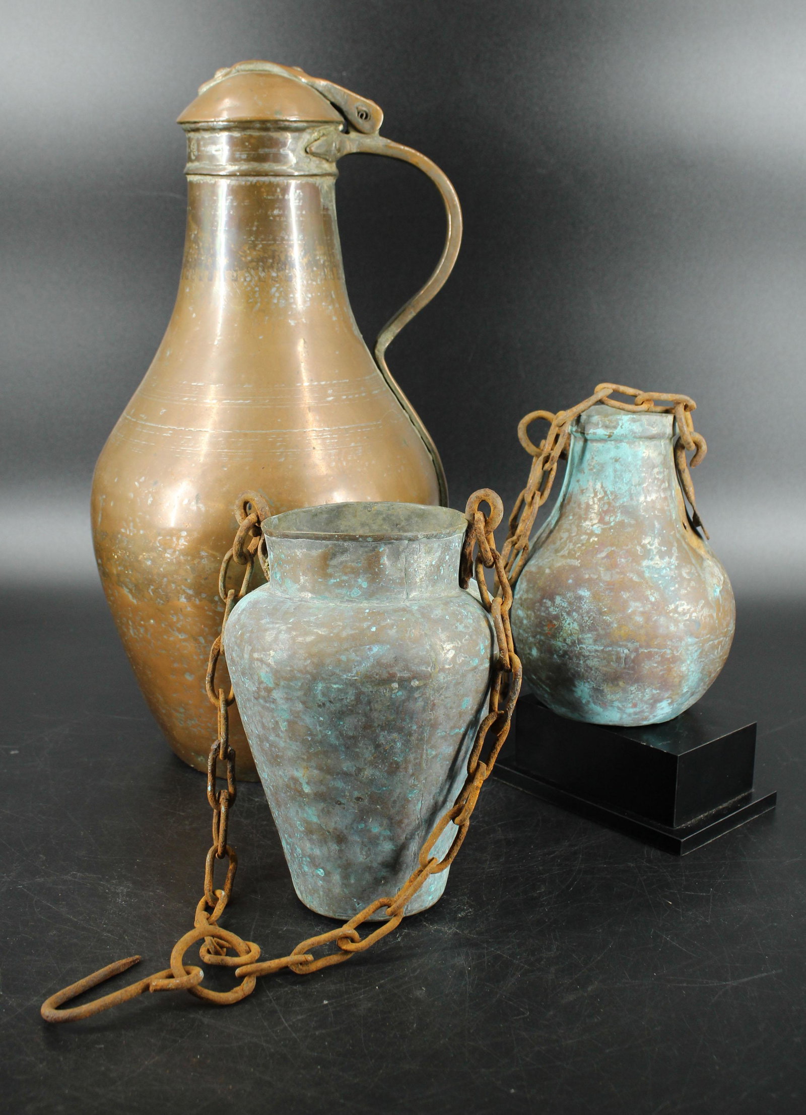 Middle Eastern Copper lot: Ewer and Pendant Verdigris Vessels. Ewer having hallmarks at neck. Size: 17.75" x 8.5" ewer, 8" jugs.