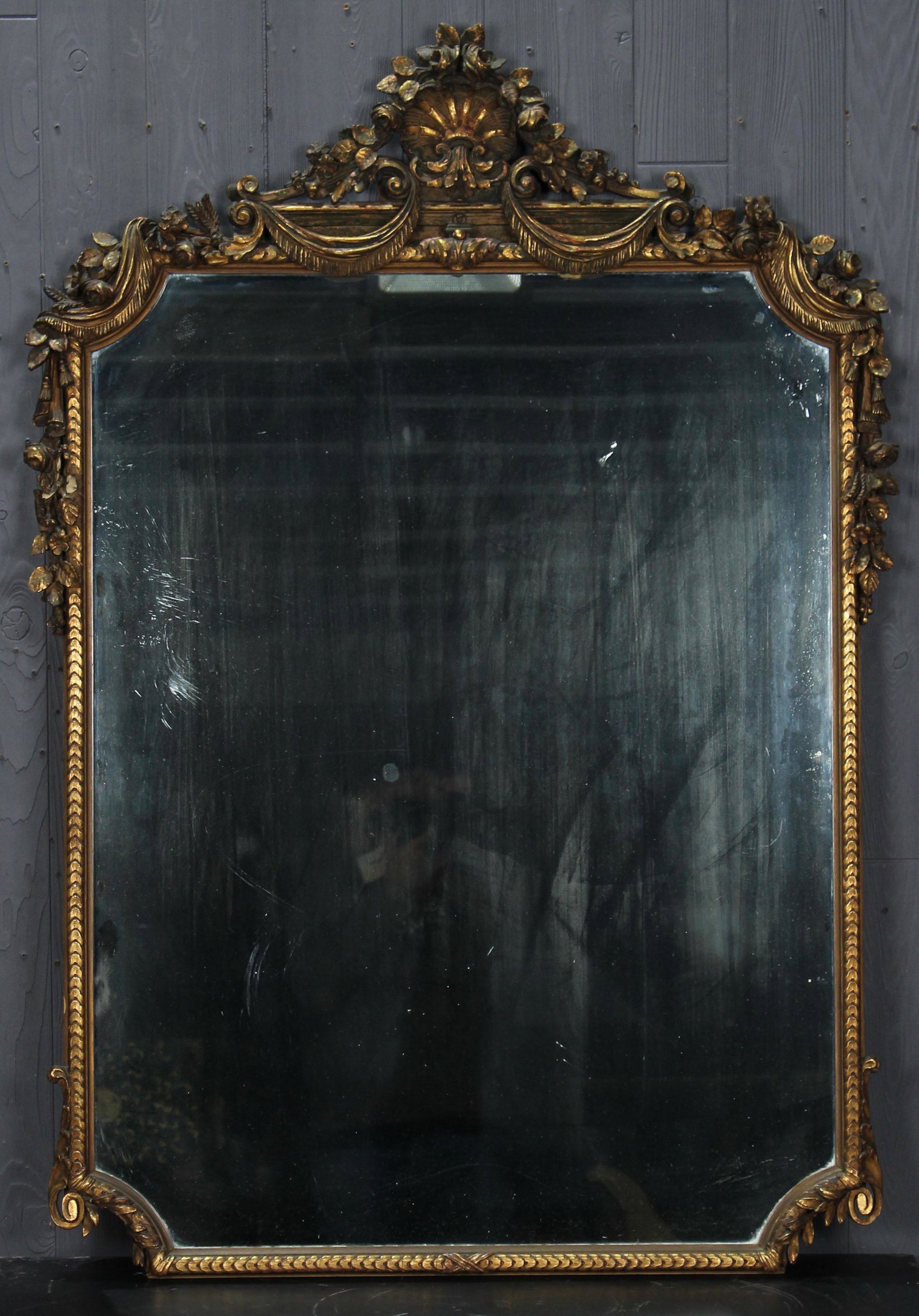Continental Carved Giltwood Frame Mirror: Mirror with Carved Giltwood Frame, floral, foliate, and swag decoration. Size: 53.5" x 27"