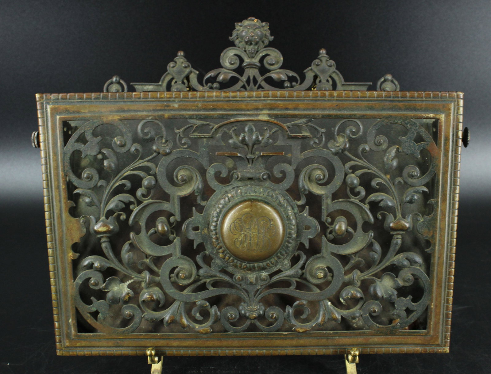 Bronze Wall Mounted Letter Holder: Bronze Wall Mounted Letter Holder, monogrammed on front, lions head mask decoration at top, foliate and scroll design. Size: 11.25" H x 13.5" W x 3.25" D