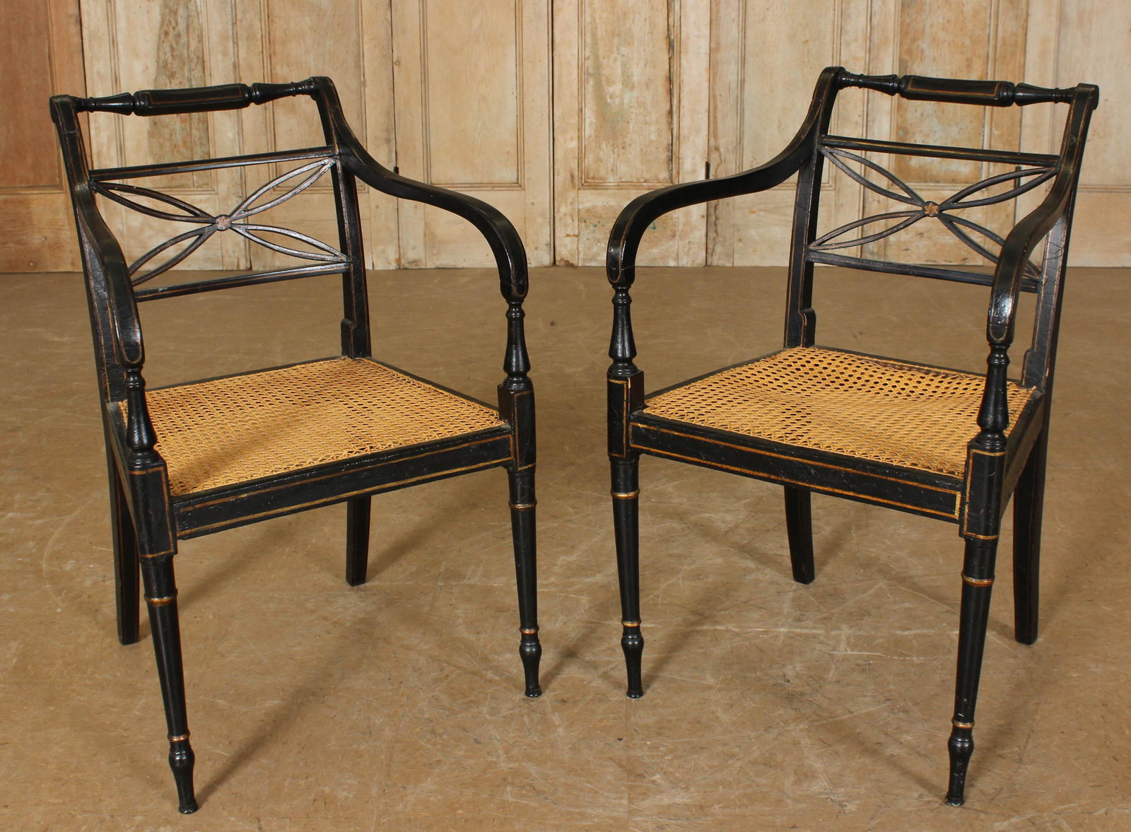 Pair of Regency Style Ebonized Chairs: Pair of Regency Style Ebonized Chairs, caned seat. Size: 62.5" H x 20.5" W x 21" D