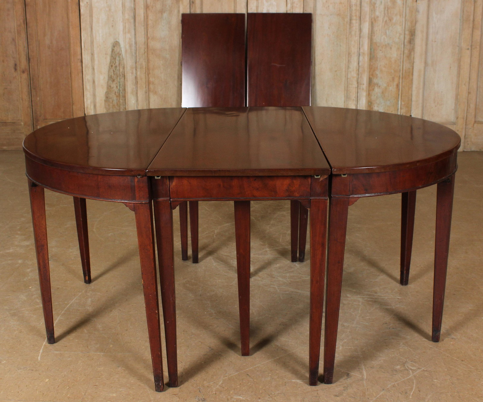 Hepplewhite Dining Room Table: Hepplewhite Dining Room Table having an oval top supported on tapered legs. 30" H x 106" W x 47.25" D