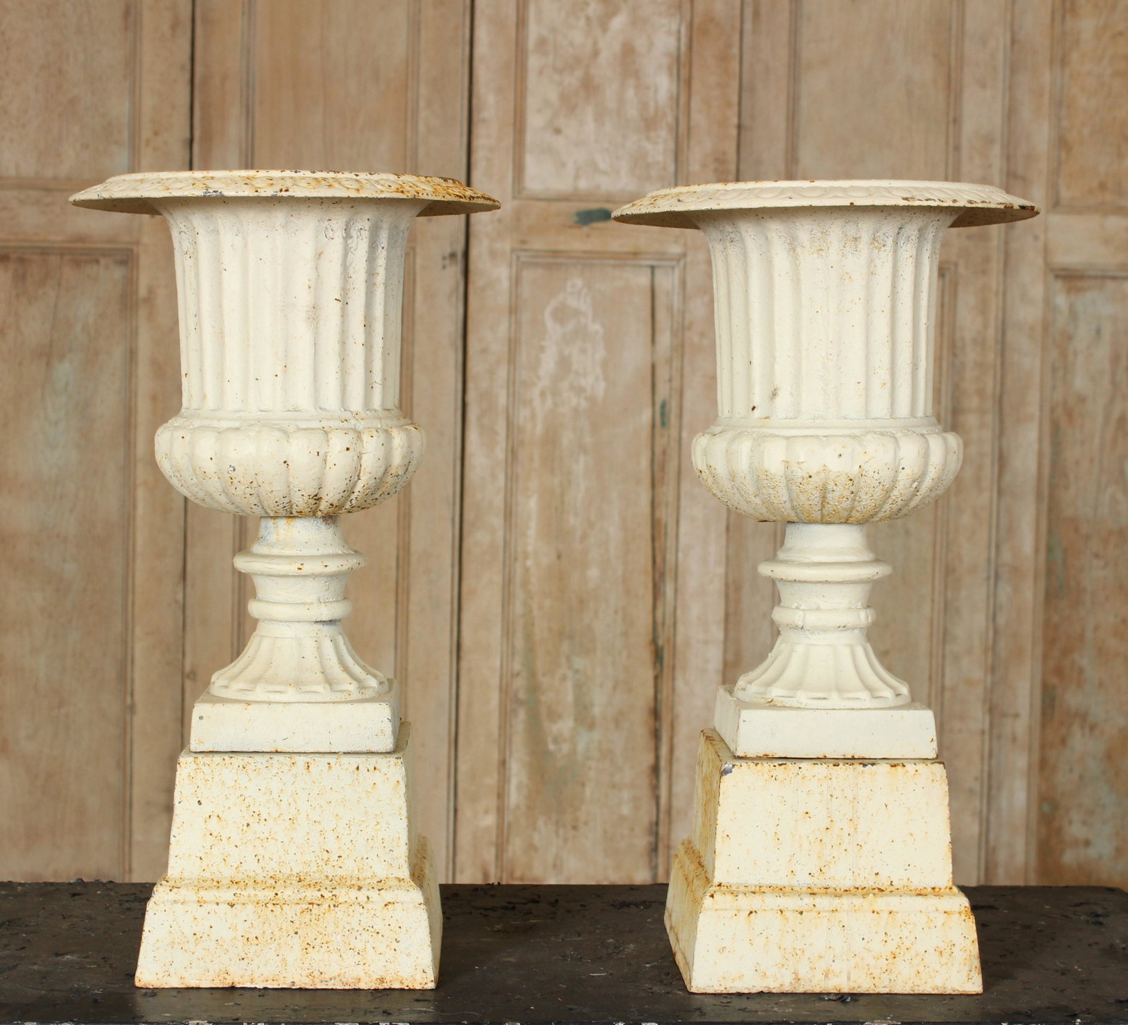 Pair of Cast Iron Urns with Bases: Pair of Cast Iron Urns with Bases. Size: 20.25" H x 11.5" Diameter