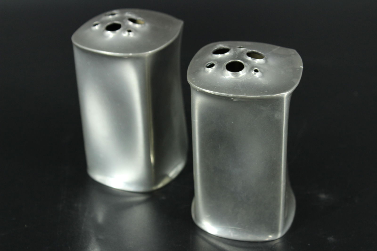 Pair of Cartier Pewter James R. Gagnon Vases: Pair of Cartier Pewter James R. Gagnon Vases, modernistic vases or desk accessories, both marked on bottom. Size: 4" x 2.5" x 2.5"