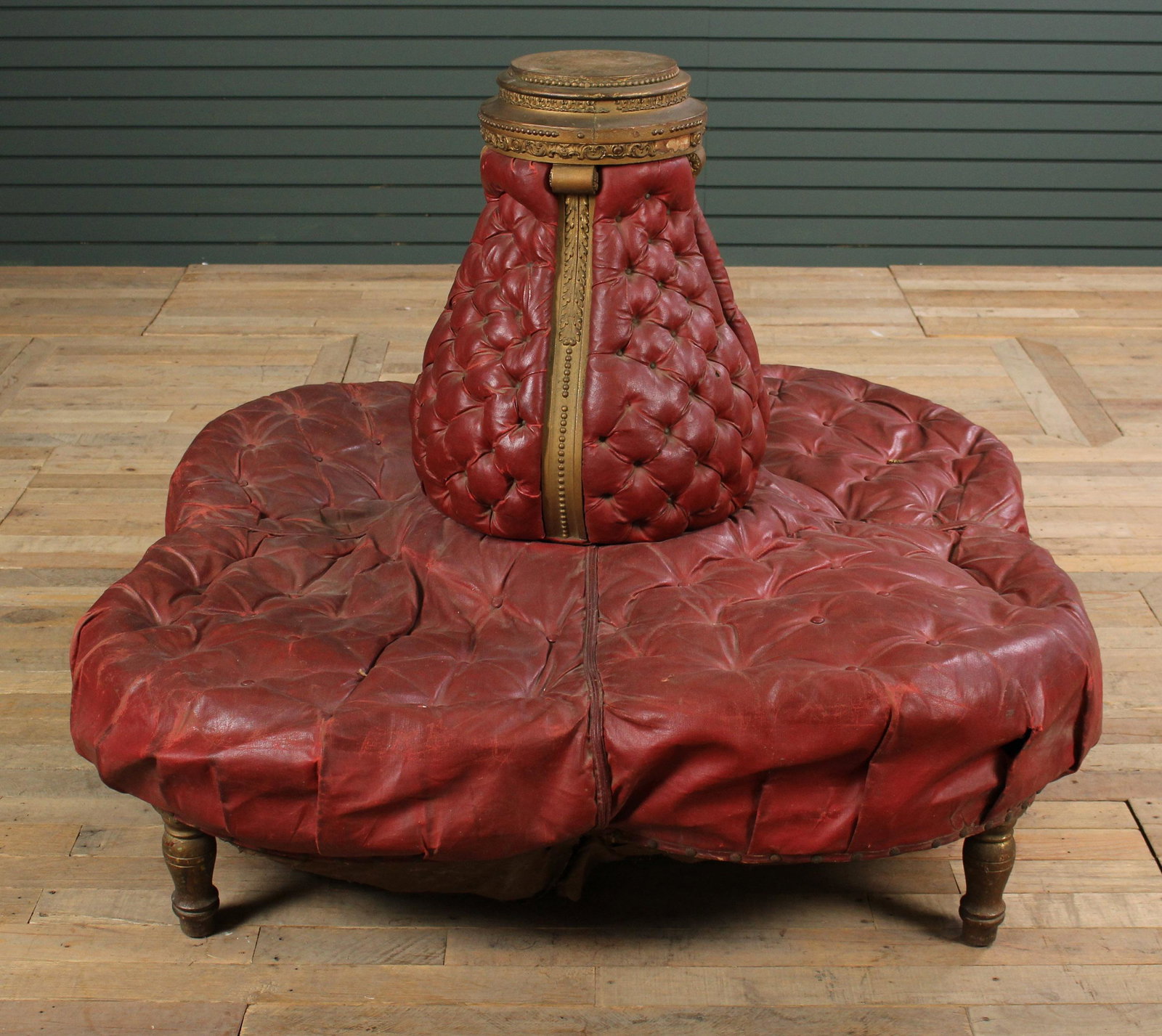 Late 19th C Giltwood and Leather Confidante Sofa: Late 19th C. Gilt Wood Carved and Leather Upholstered Confidante Sofa, confidante having central back rest with gilt carvings framed by 4 sections of seating. Size: 45" H x 46" W x 46" D.