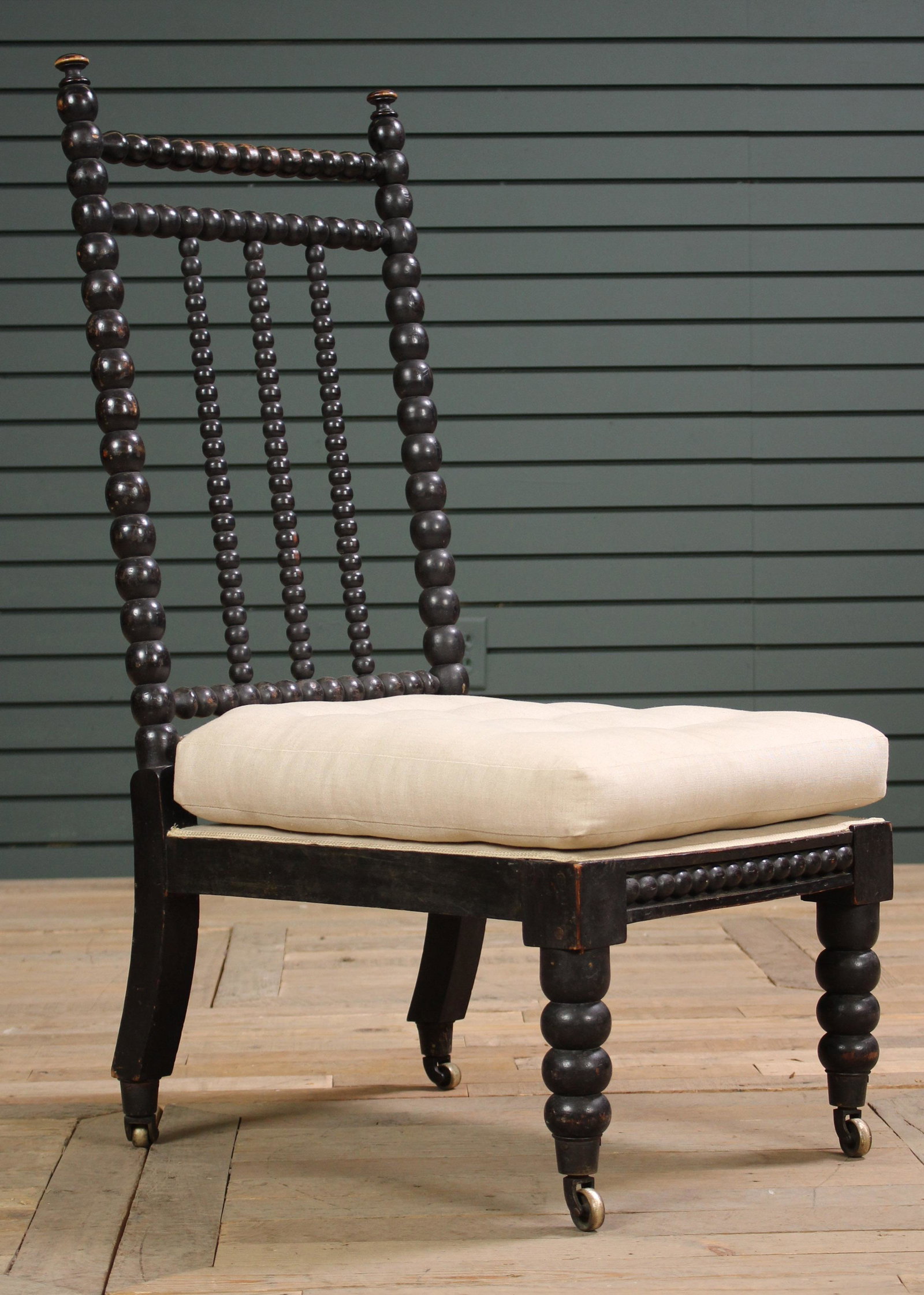 19th C. French Ebonized Spool Turned Slipper Chair: 19th C. French Ebonized Spool Turned Slipper Chair having loose cushion seat and turned legs. Size: 39" H x 17" W x 22" D. Seat Height: 15" H.