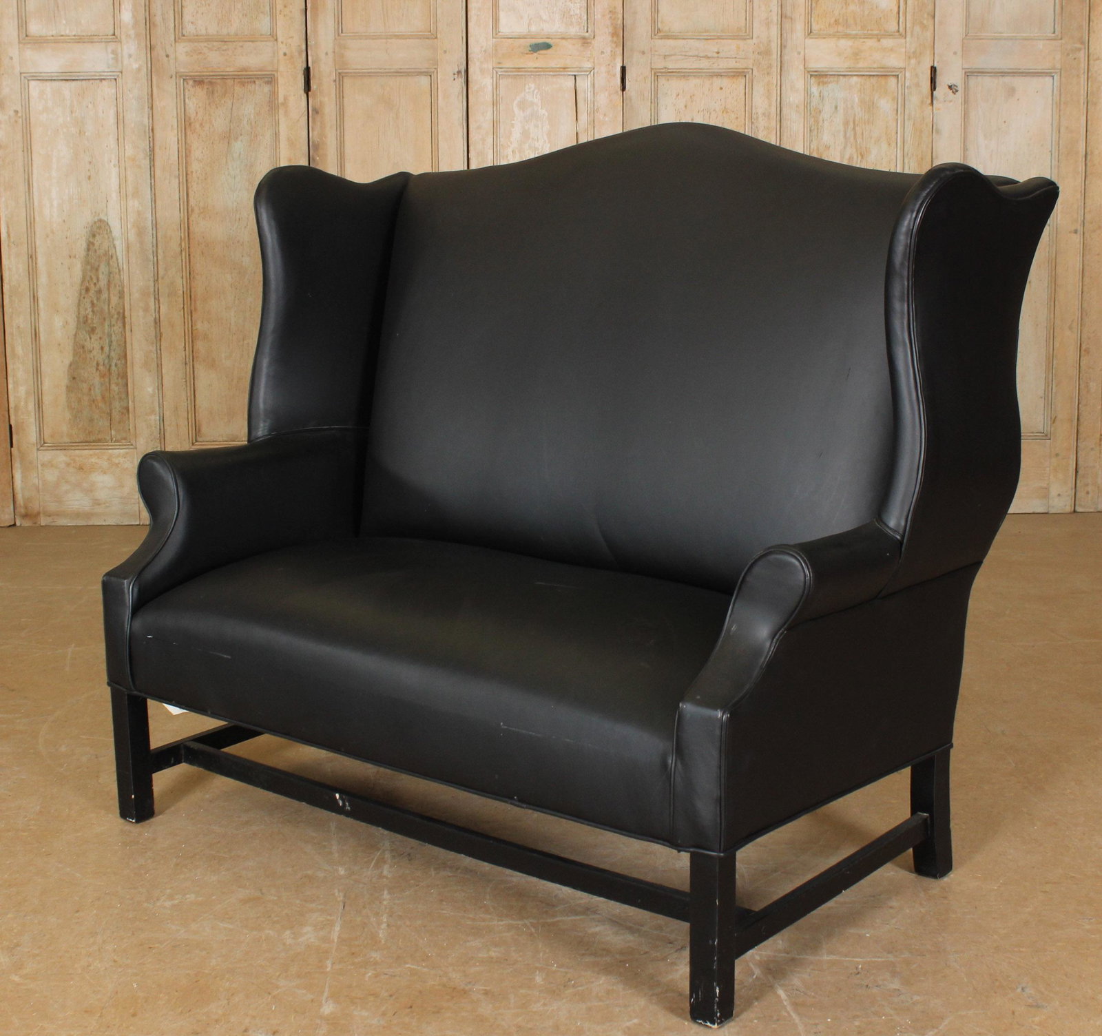 Johnston Benchworks Black Leather Wingback Settee: Johnston Benchworks Black Leather Settee, label on back. 47.5" H x 56.25" W x 35" D