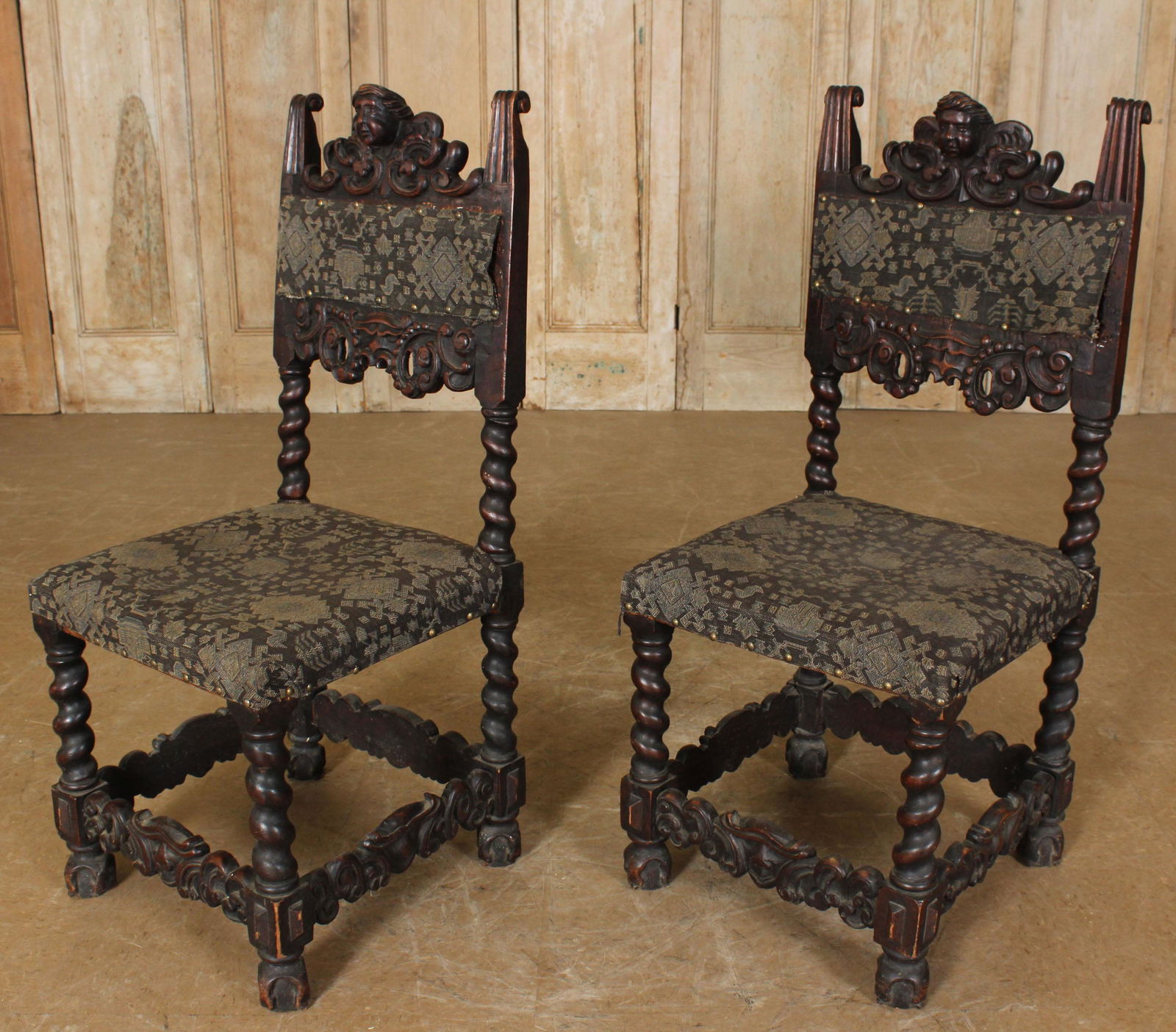 Pair of Portuguese Side Chairs: Pair of Portuguese Side Chairs, embossed upholstery with tack trim, carved mask decoration on crest and on stretcher, barley twist legs, ball and claw feet. 41.75" H x 19" W x 19.5" D