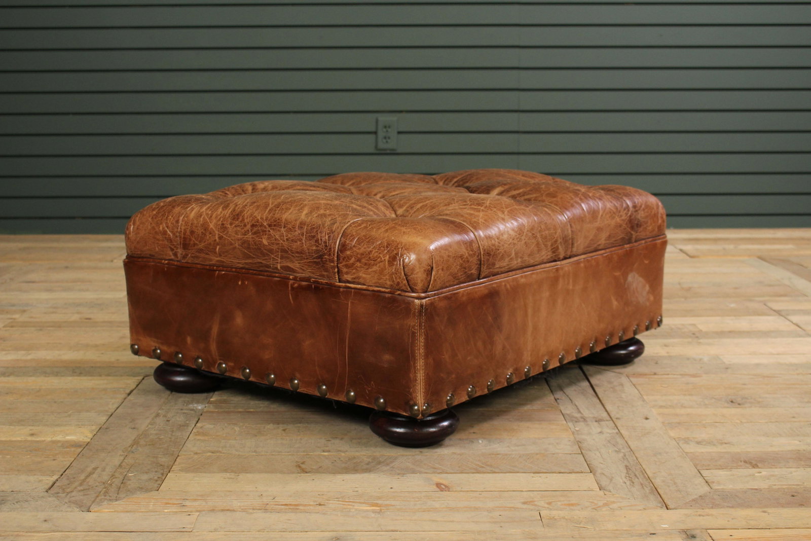 Labeled Ralph Lauren Leather Tufted Ottoman: Labeled Ralph Lauren Leather Tufted Ottoman with nail head decoration, great color. Size: 13.5" H x 32" W x 26" D.